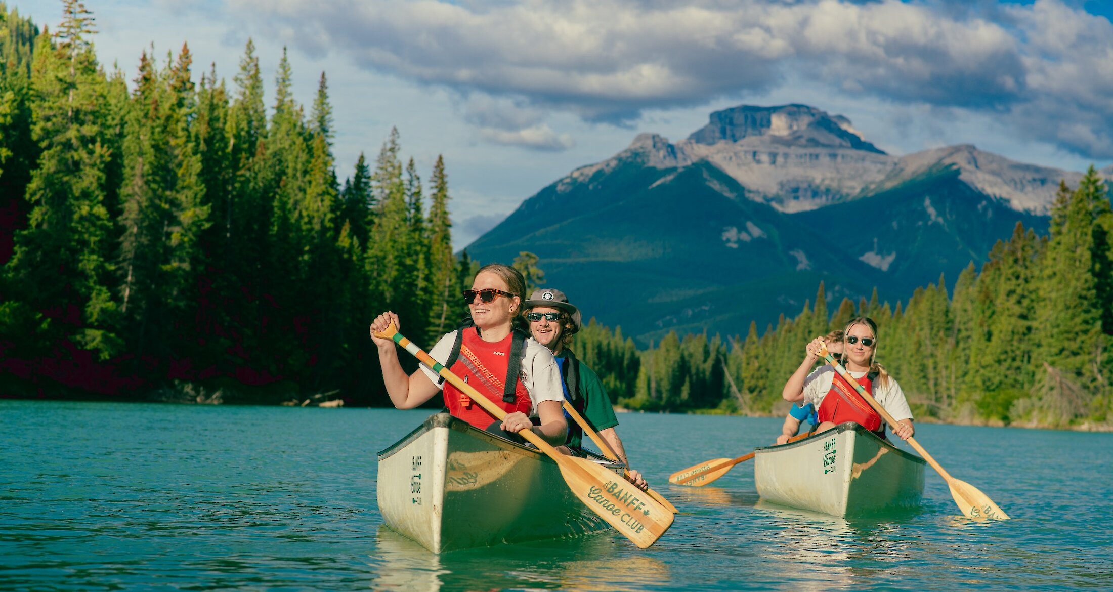 2 Canoes on the Bow River in Banff with Mountain backgrounds