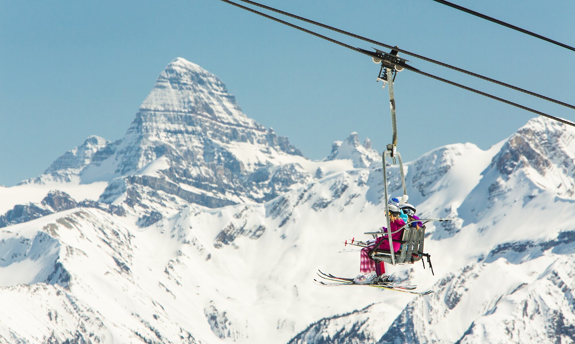 Skiers on a chairlift at Sunshine Village Ski Resort