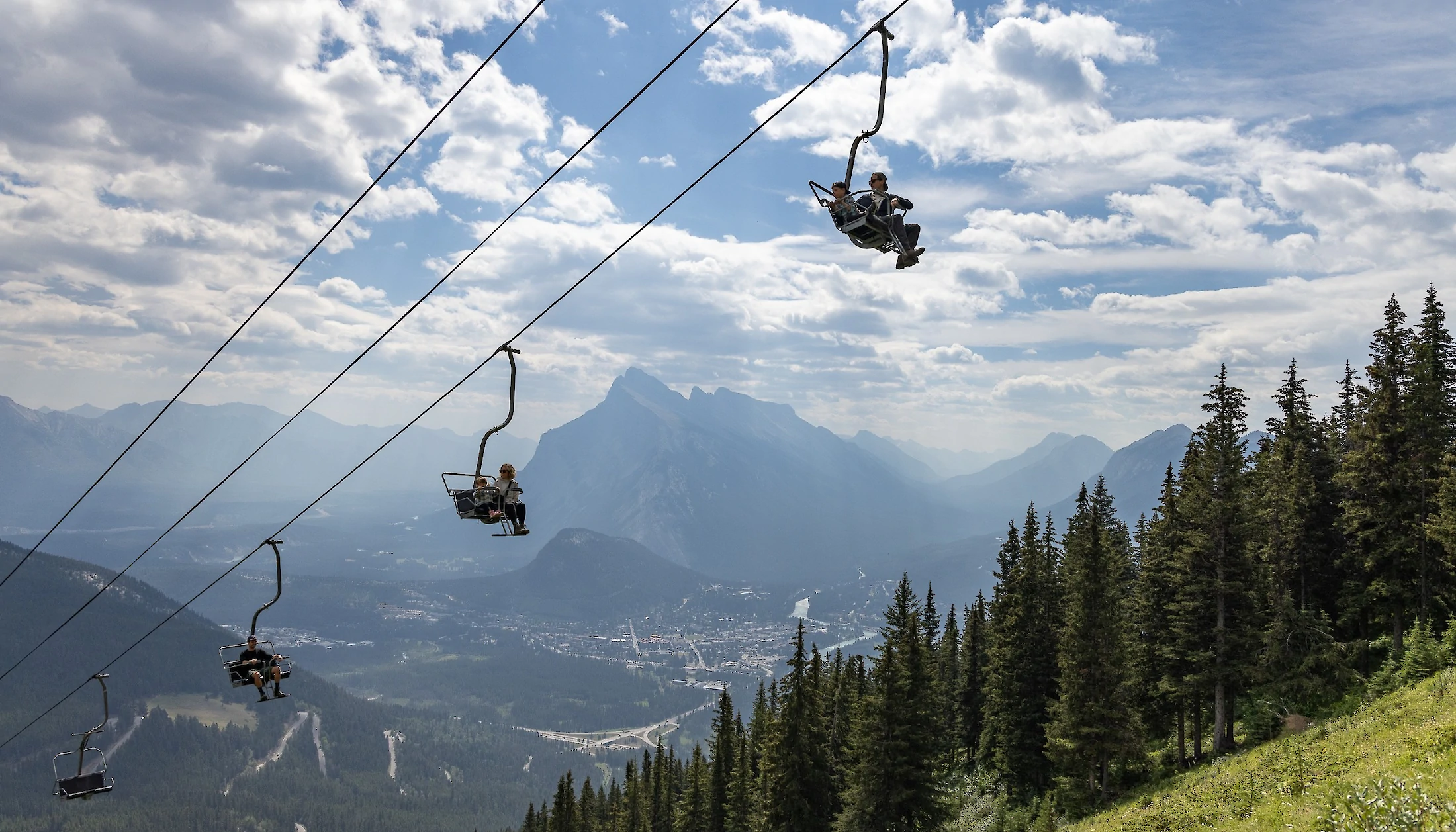 A family riding the Banff Sightseeing Chairlift at Mount Norquay