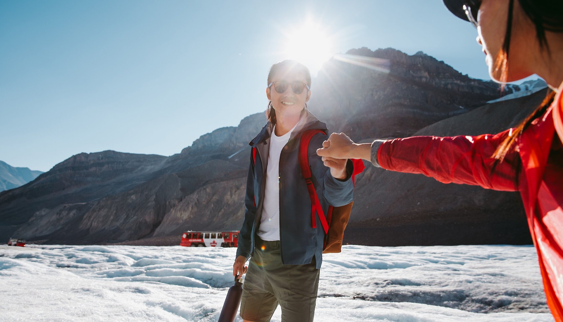 A couple holding hands on the Columbia Icefield Adventure