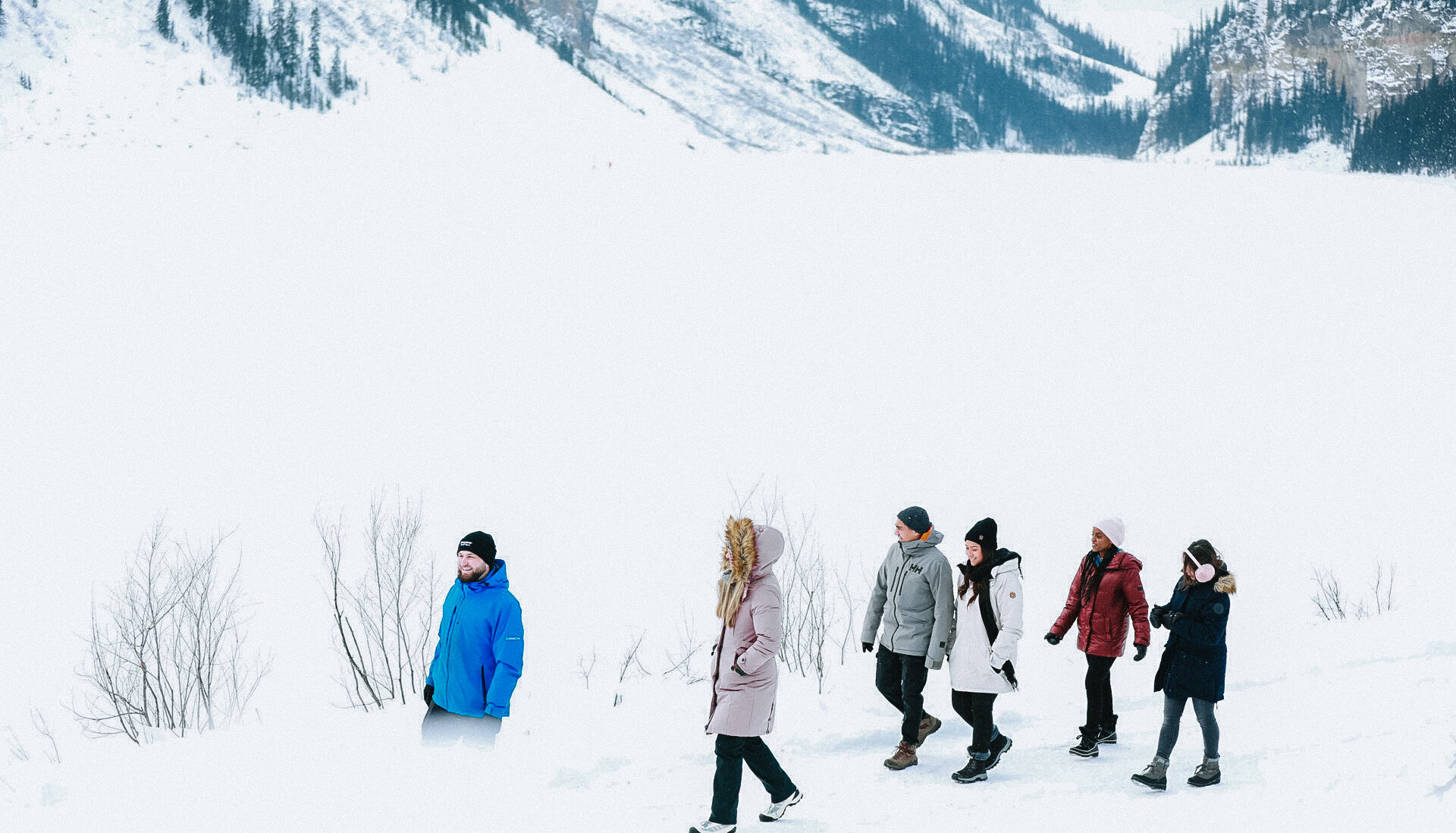 A guided tour walking along Lake Louise Shoreline in Winter
