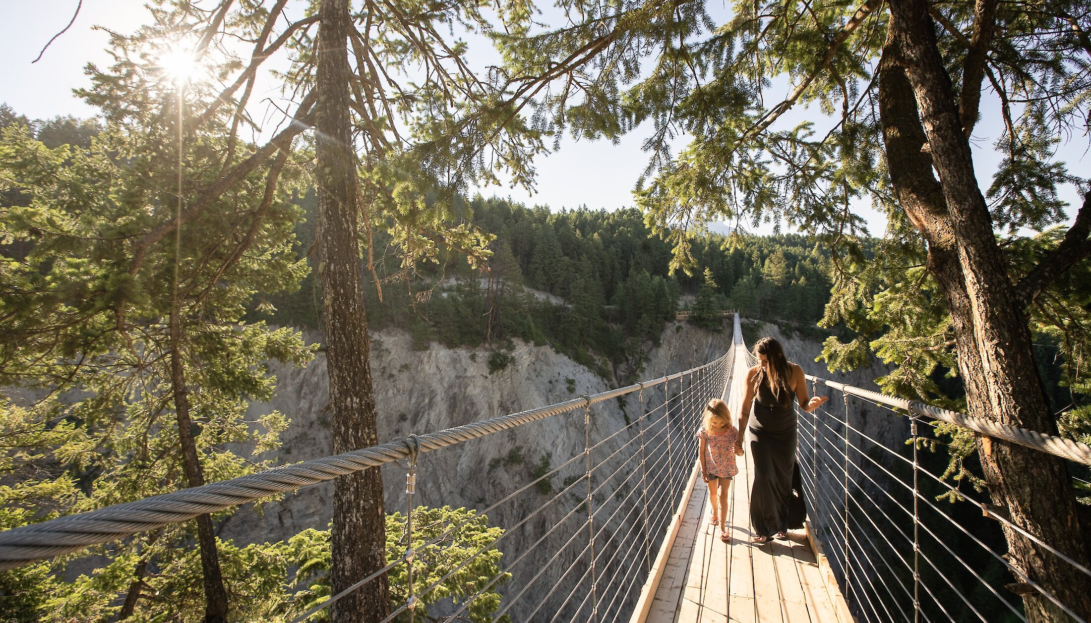 A mother and daughter walking across the Golden Skybridge
