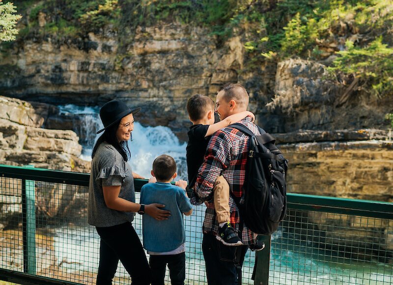 A family admiring the view at Johnston Canyon
