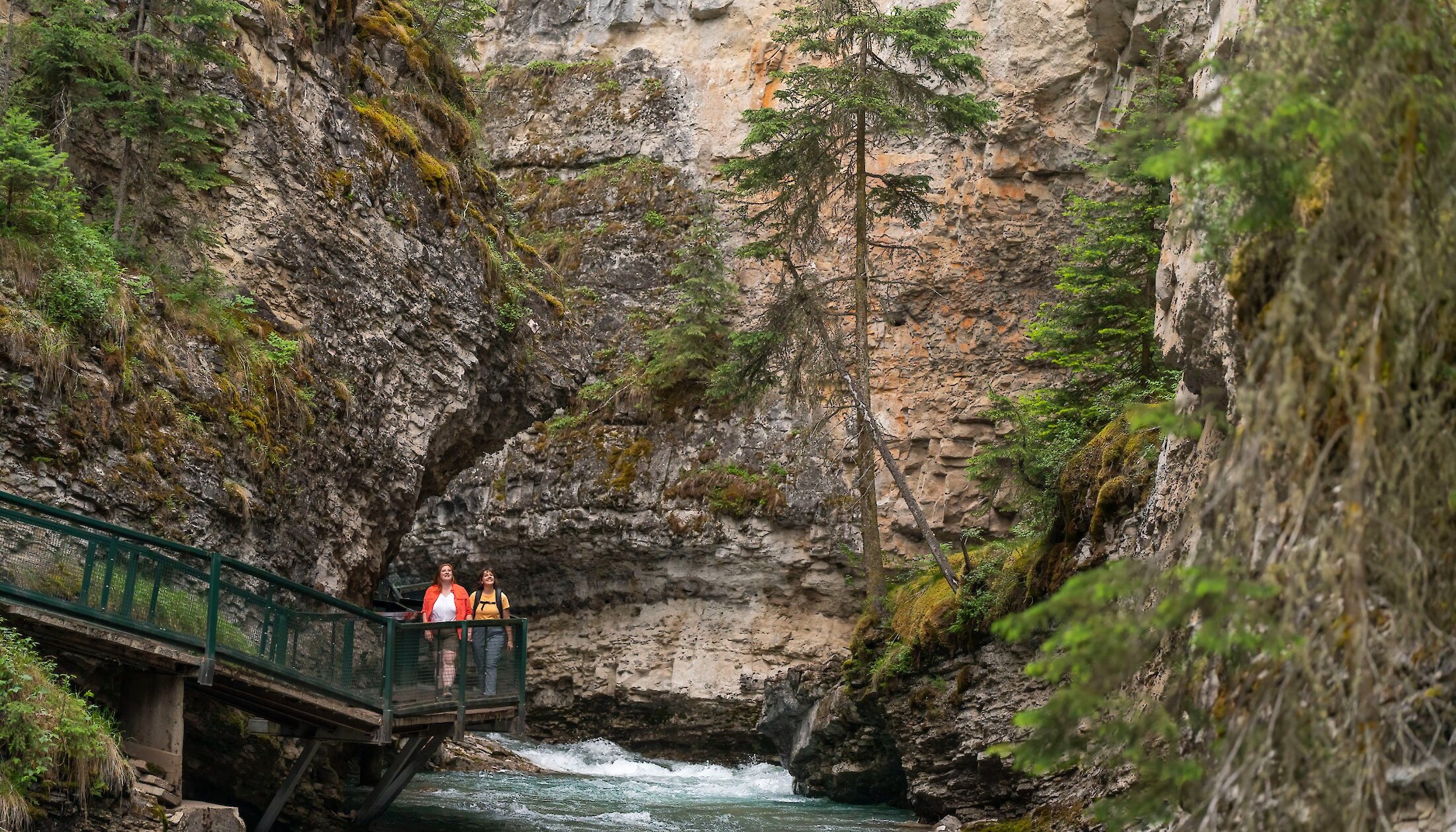 Two friends hiking the catwalks at Johnston Canyon