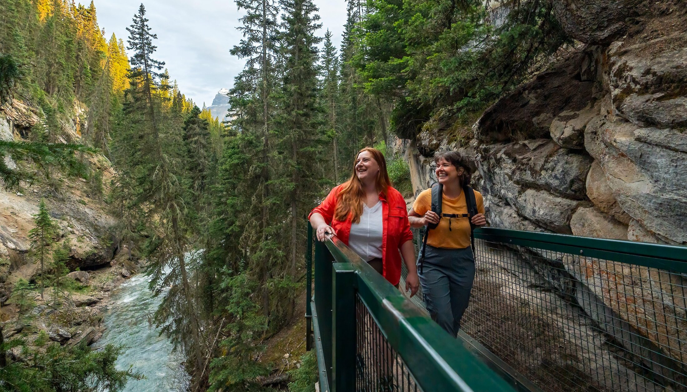 Two friends walking along the catwalks of Johnston Canyon