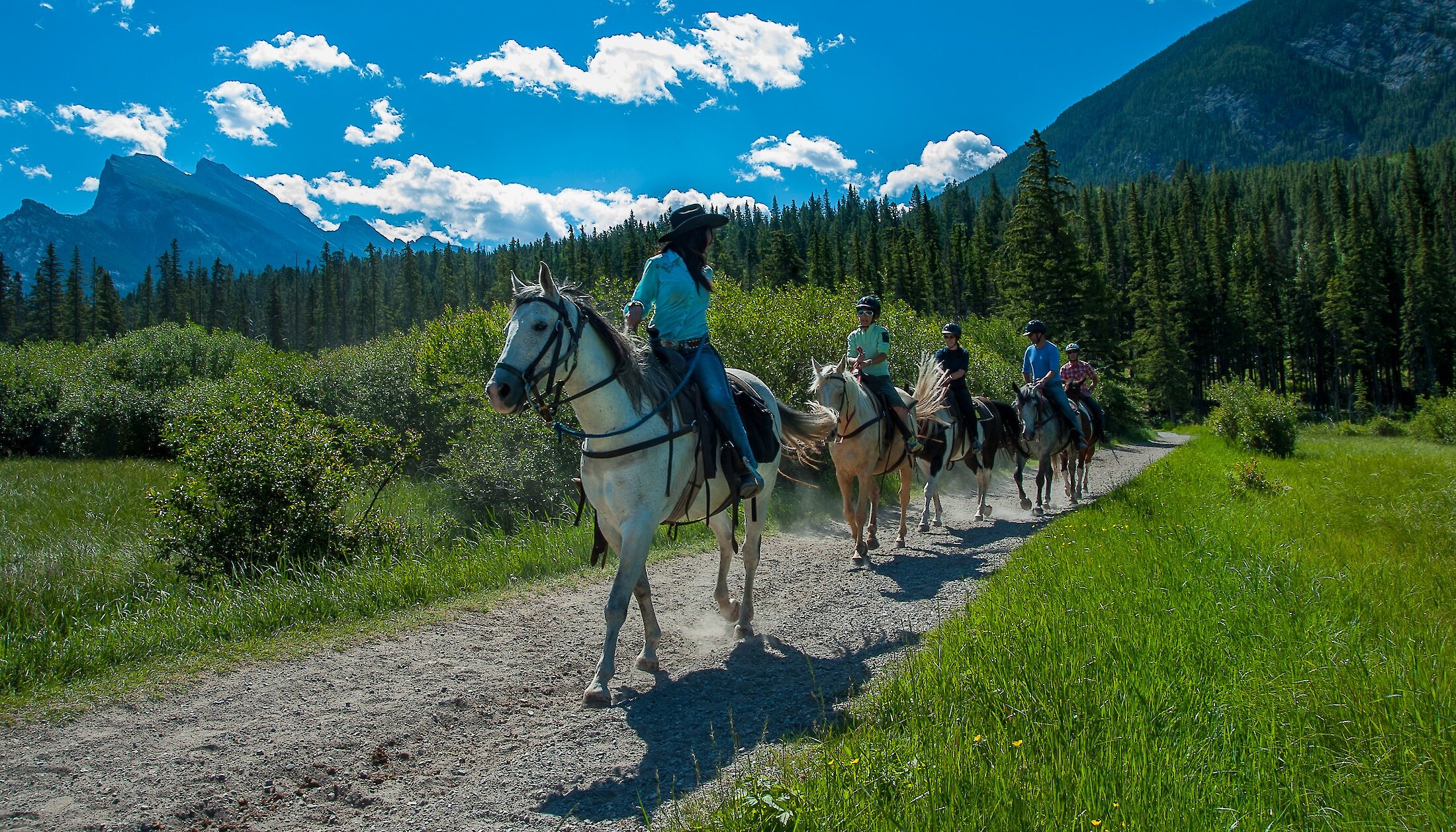 A group of horseback riders on the Bow River Trail