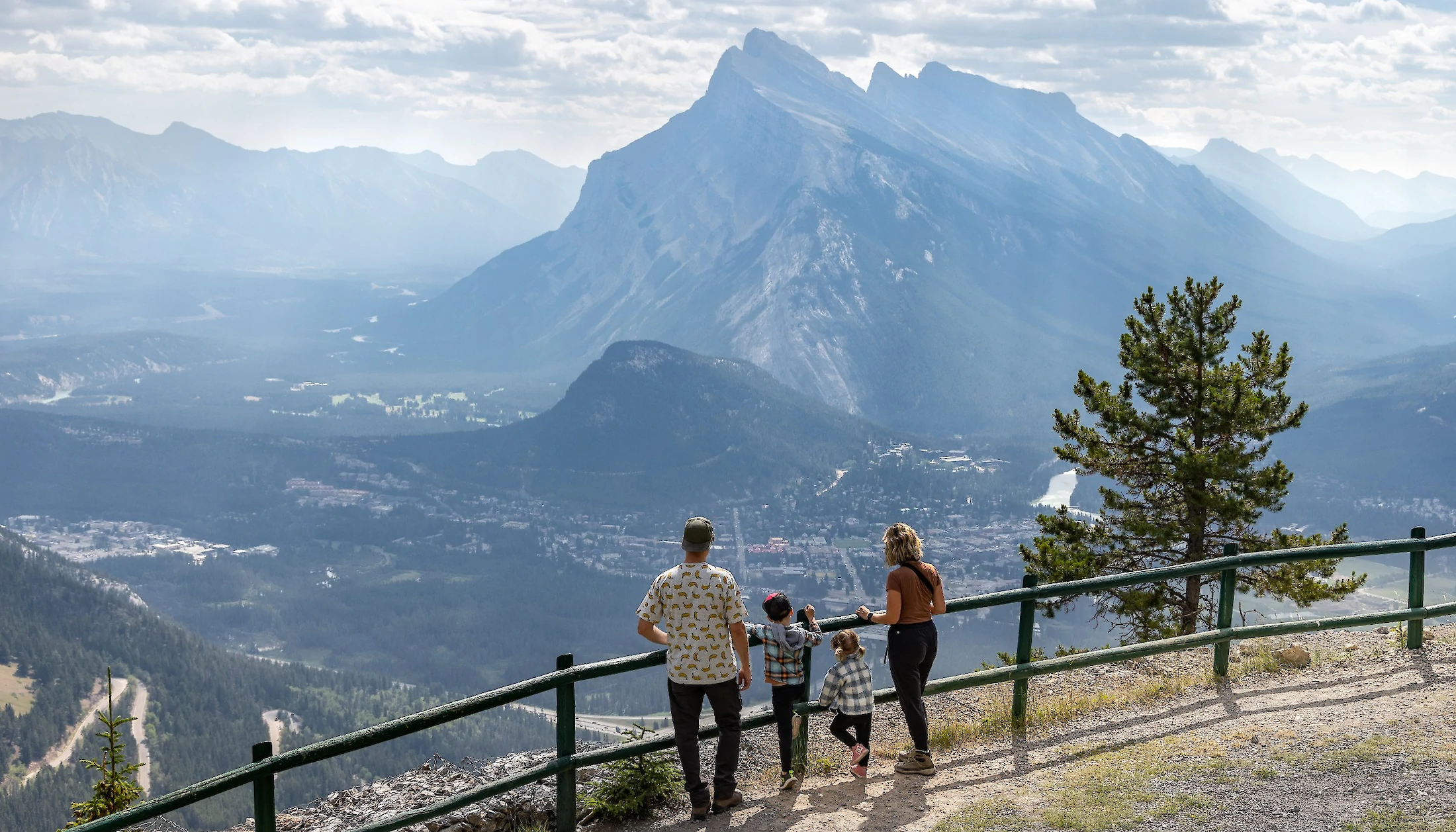 A family enjoying the view over Banff town from Mount Norquay Chairlift
