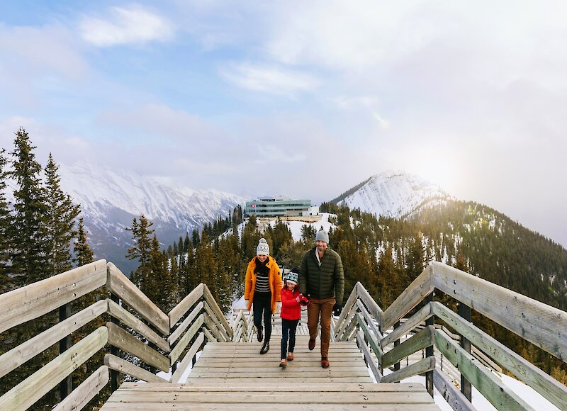 A family walking along the boardwalks of the Banff Gondola