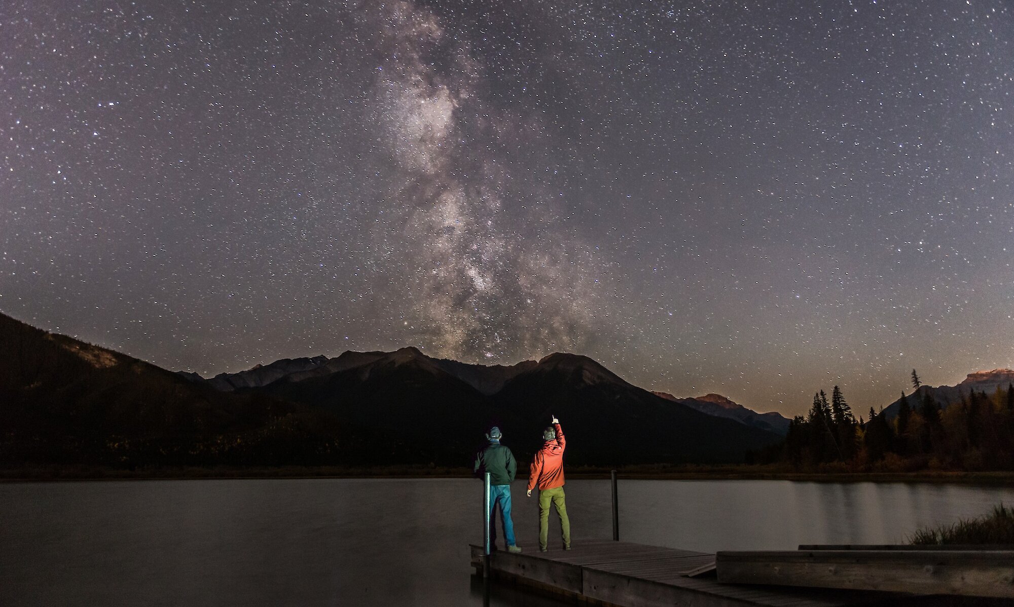 Two friends stargazing at Vermillion Lakes in Banff National Park