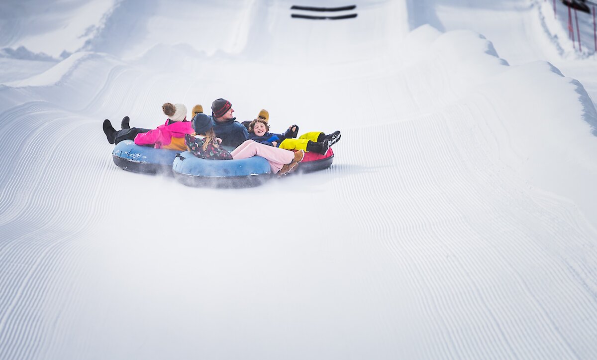 A family snow tubing at Lake Louise