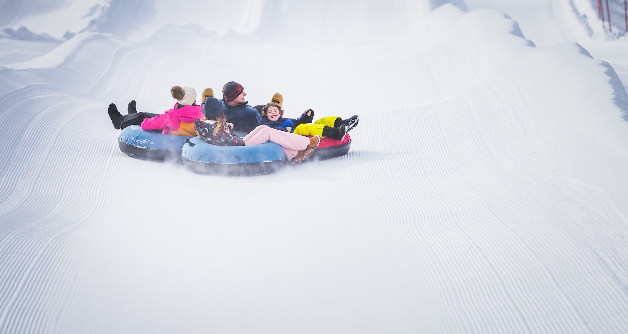 A family snow tubing at Lake Louise