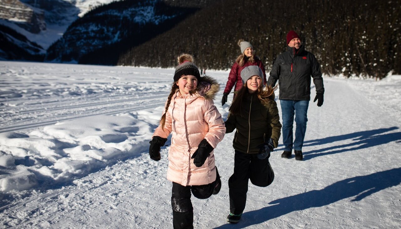 Family having fun at Lake Louise in winter