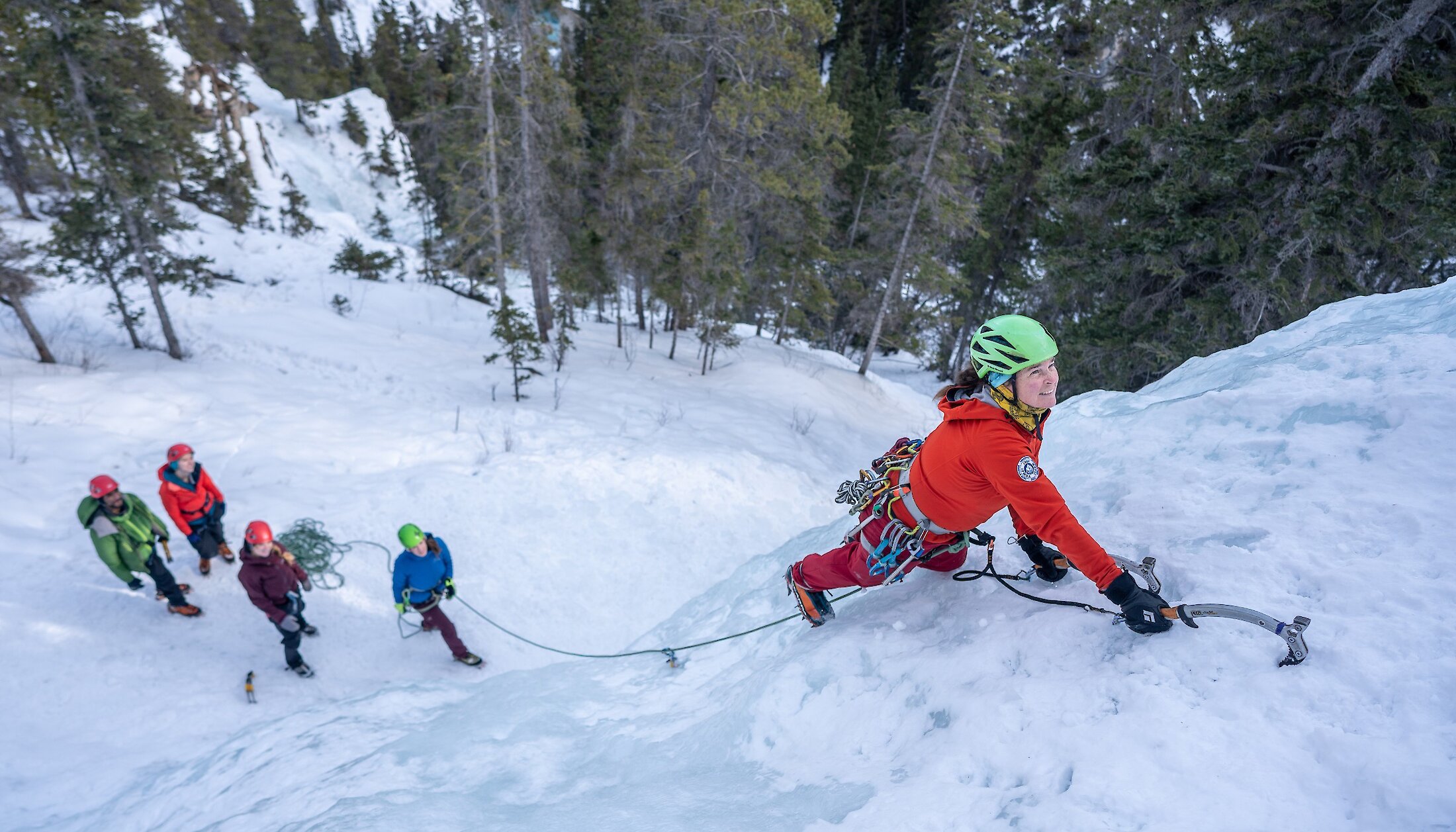 A women learning how to ice climb in the Junkyards in Canmore