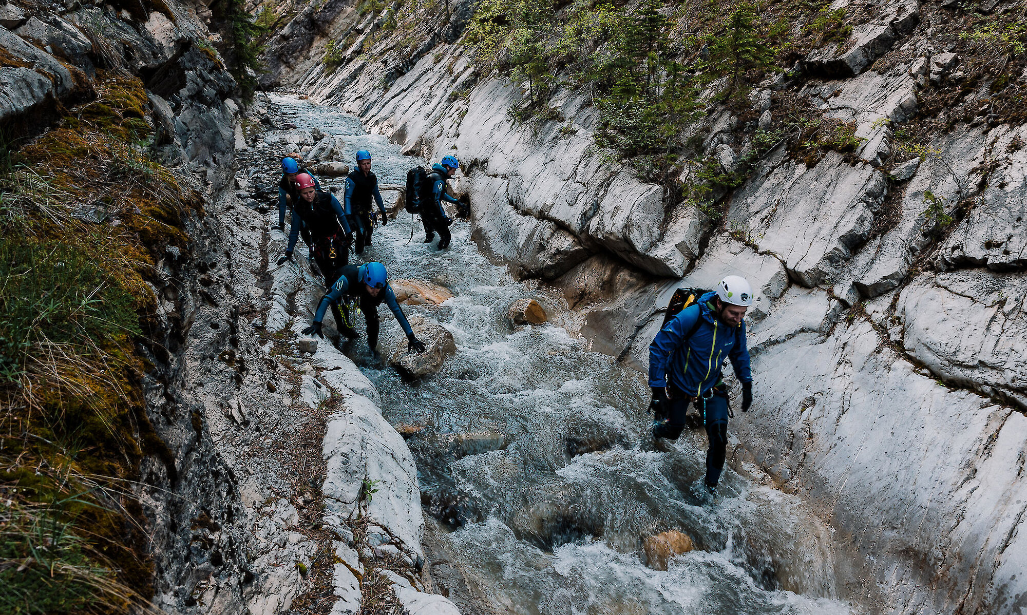 Tour group walking through White Goat Falls Canyon