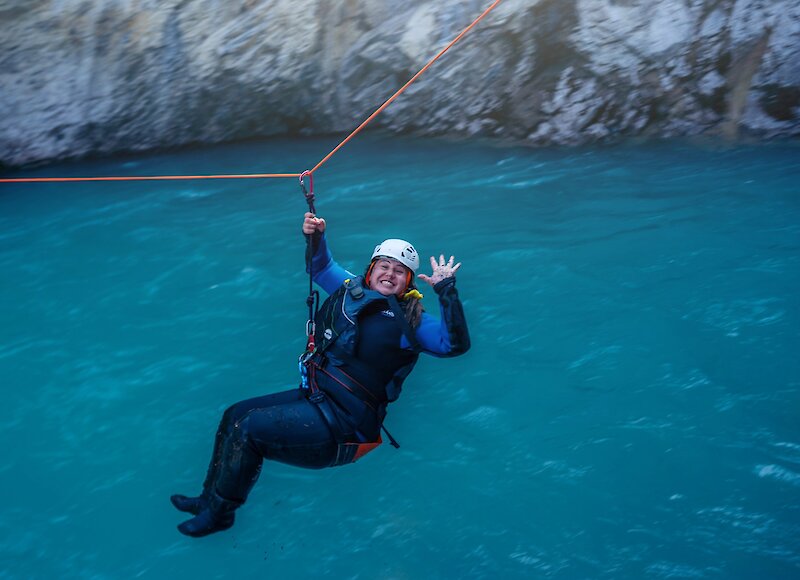 Tour guest waving while taking part in the Aquatic Canyon Tour