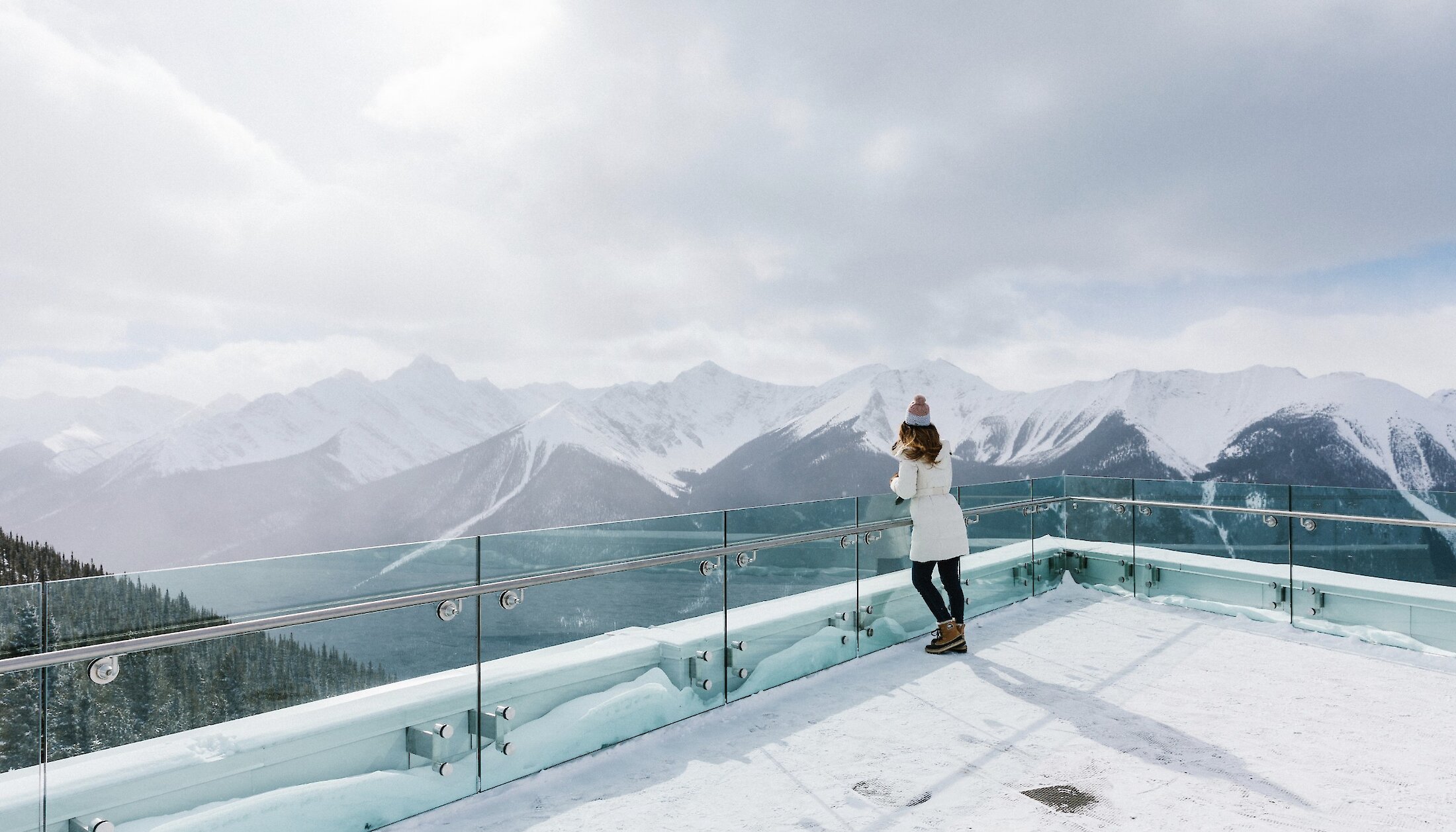 lady gazing at the frozen ice falls at Johnston Canyon