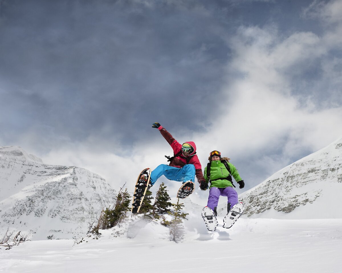 Two guests enjoying snowshoe rentals in Banff National Park