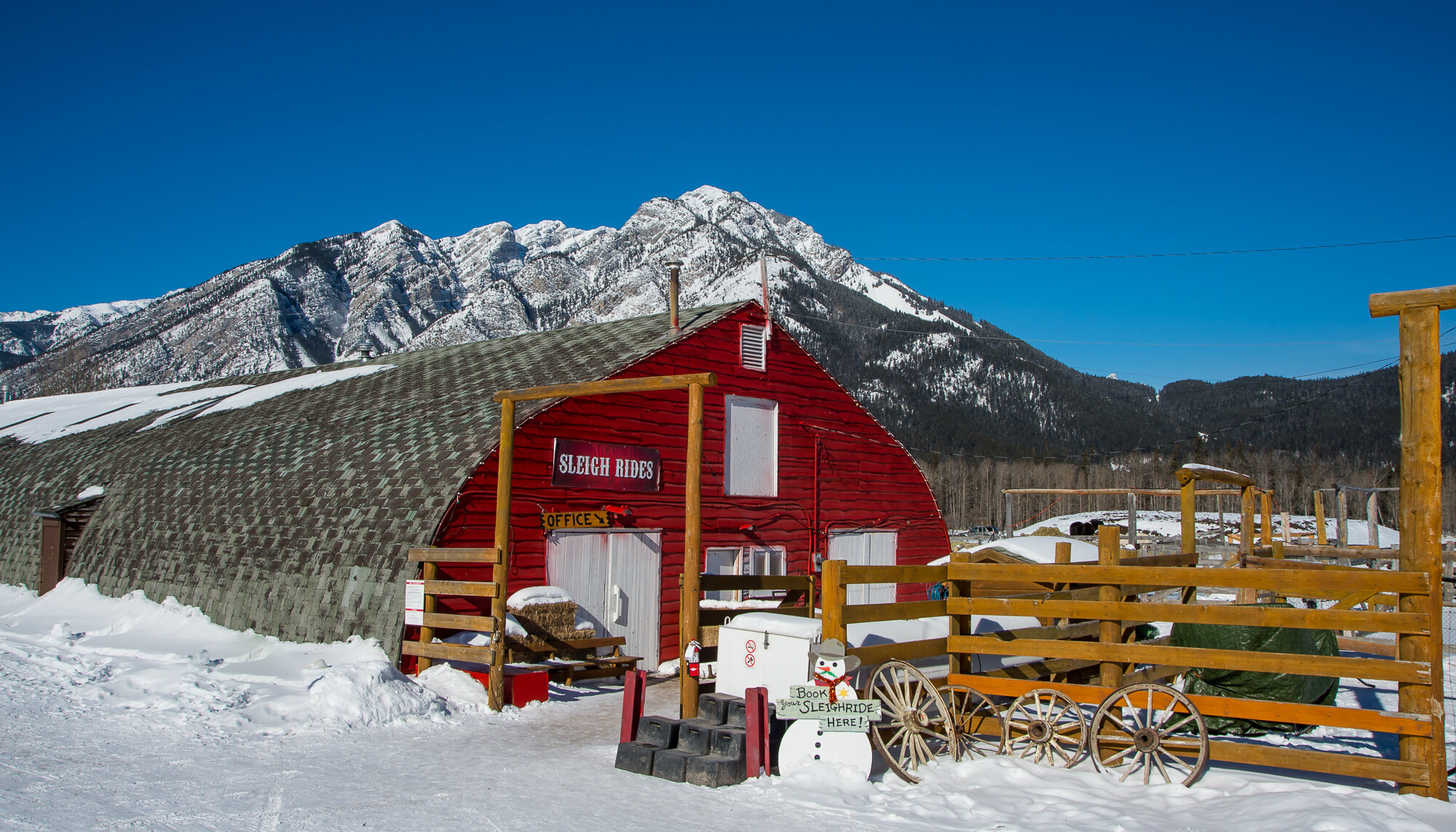 The Banff Warner Stables on a bluebird day with clear mountain views