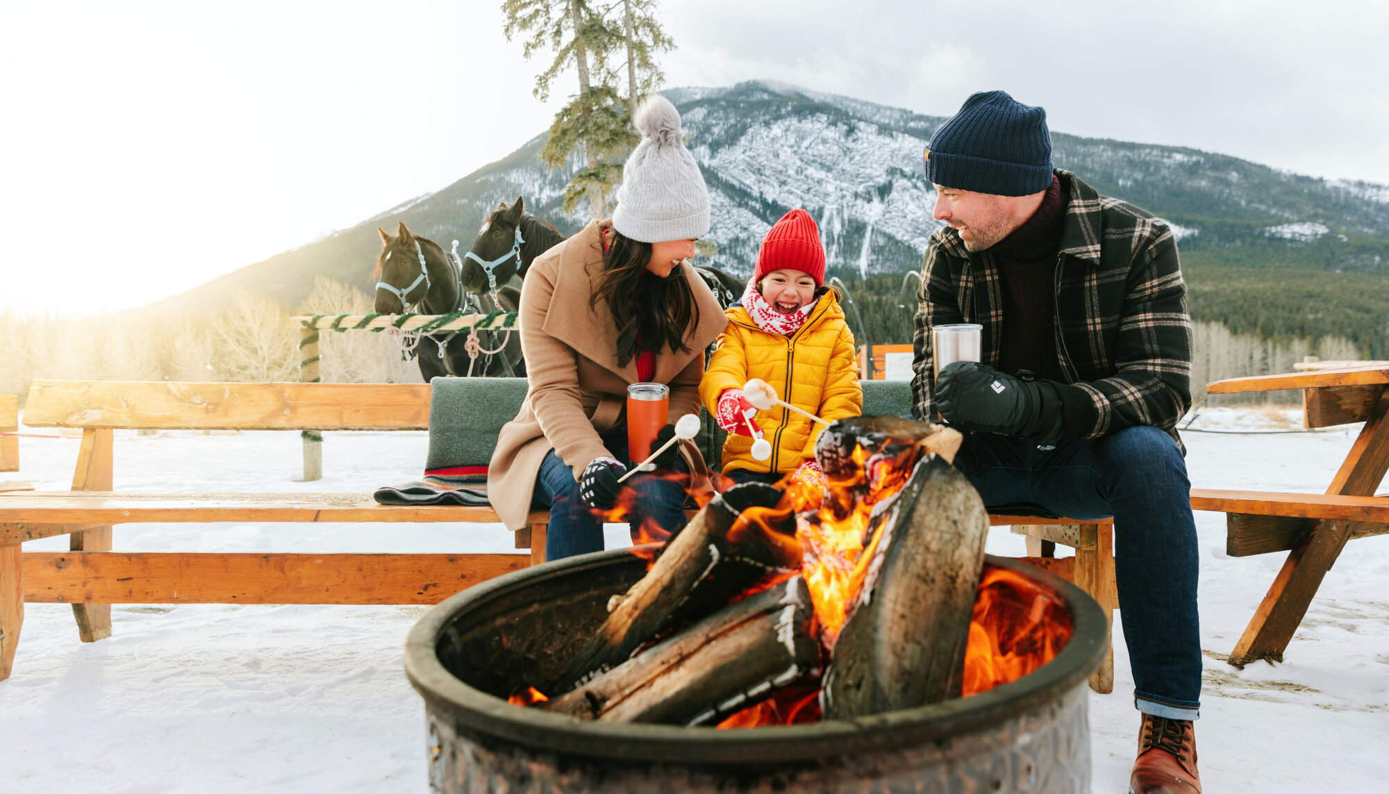 A family warm up by the fire at the Warner Stables in Banff after a sleigh ride
