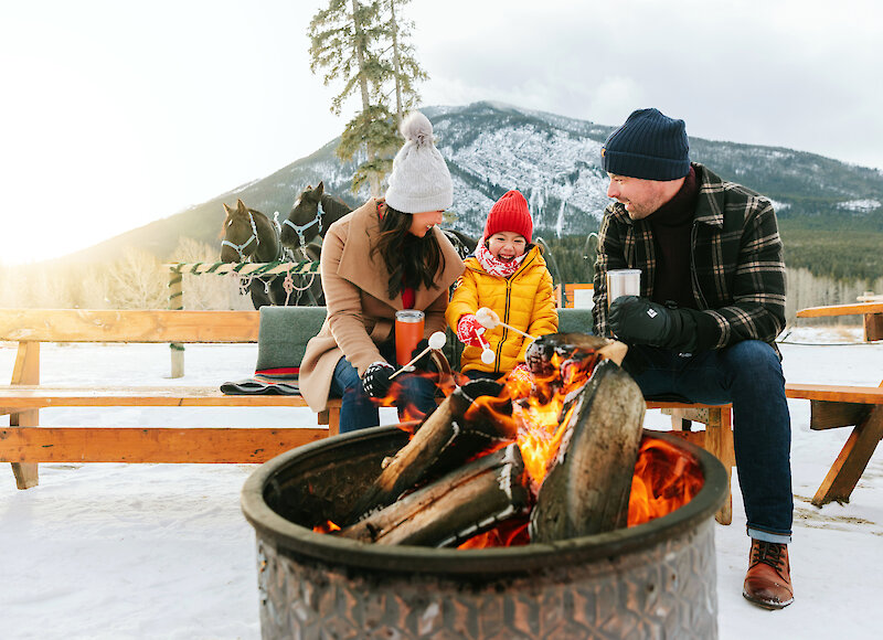 Family around the fire pit after the sleigh ride