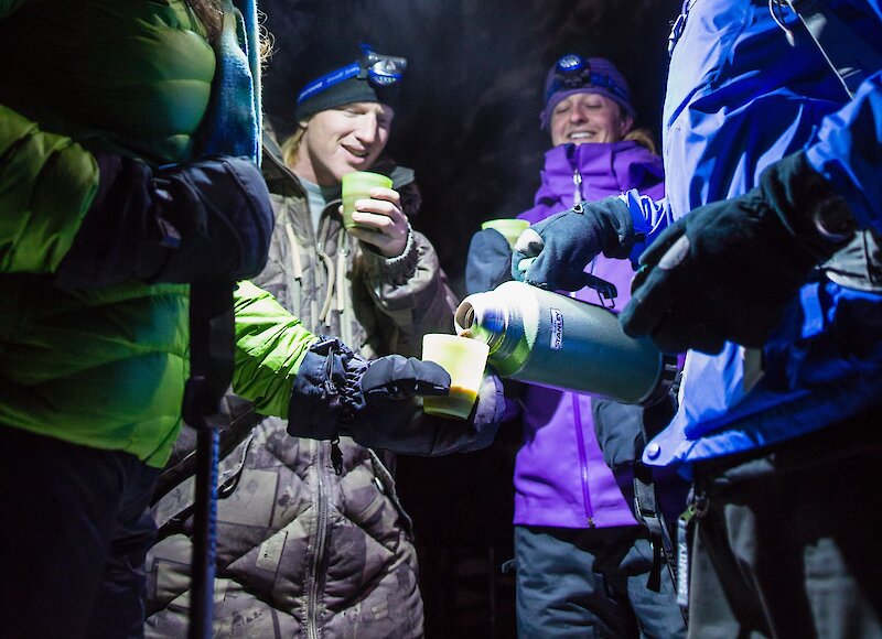 Enjoying a hot chocolate by headlamp, in Johnston Canyon at night