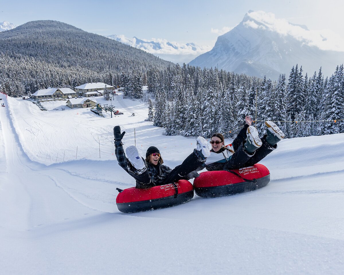 Two friends Snow Tubing at Mount Norquay