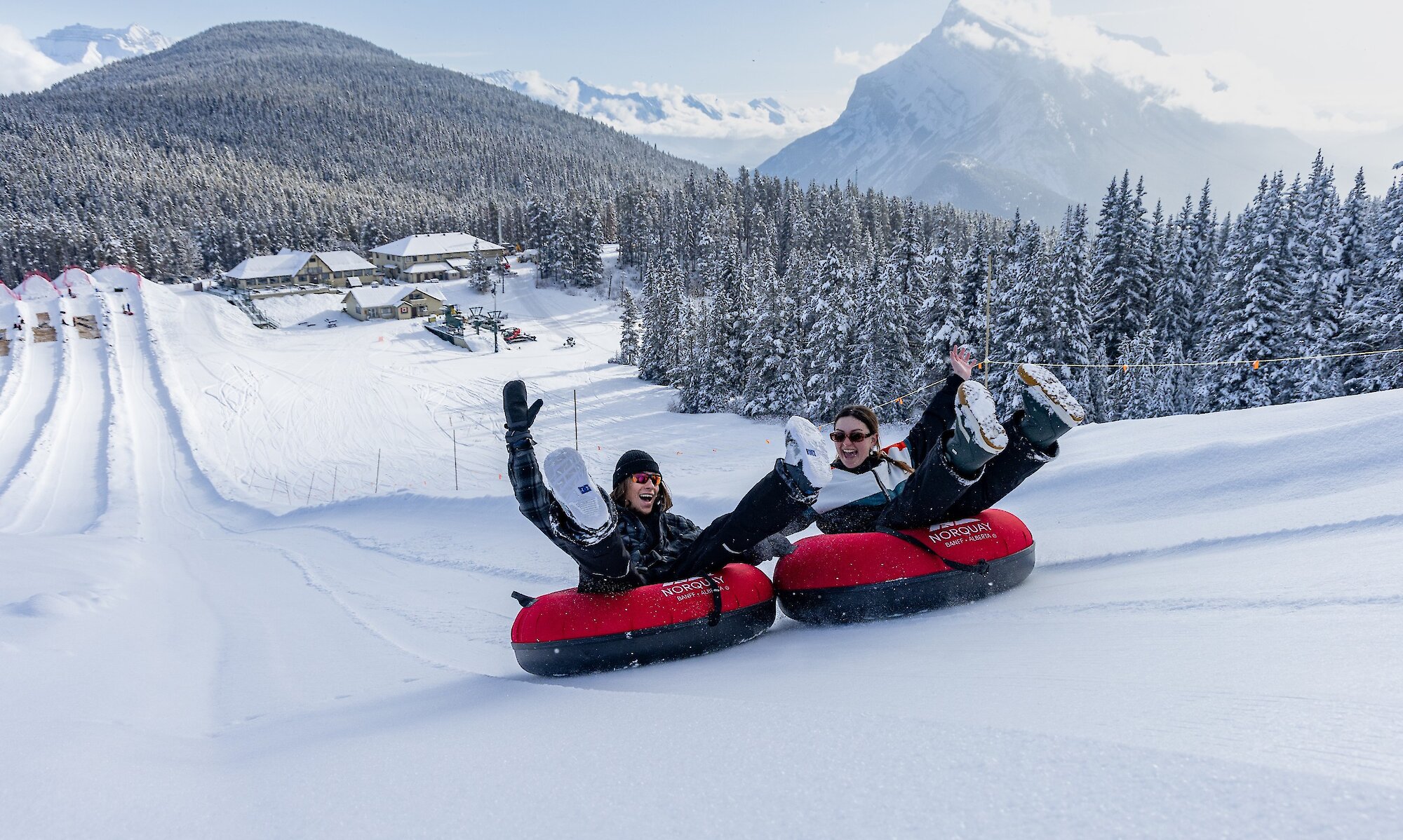 Two friends Snow Tubing at Mount Norquay