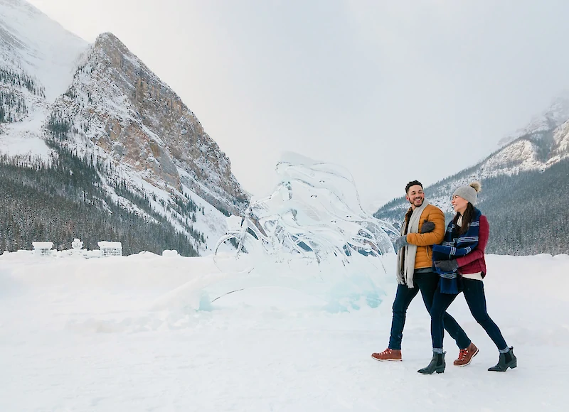 Guests checking out the ice carvings at Lake Louise in winter