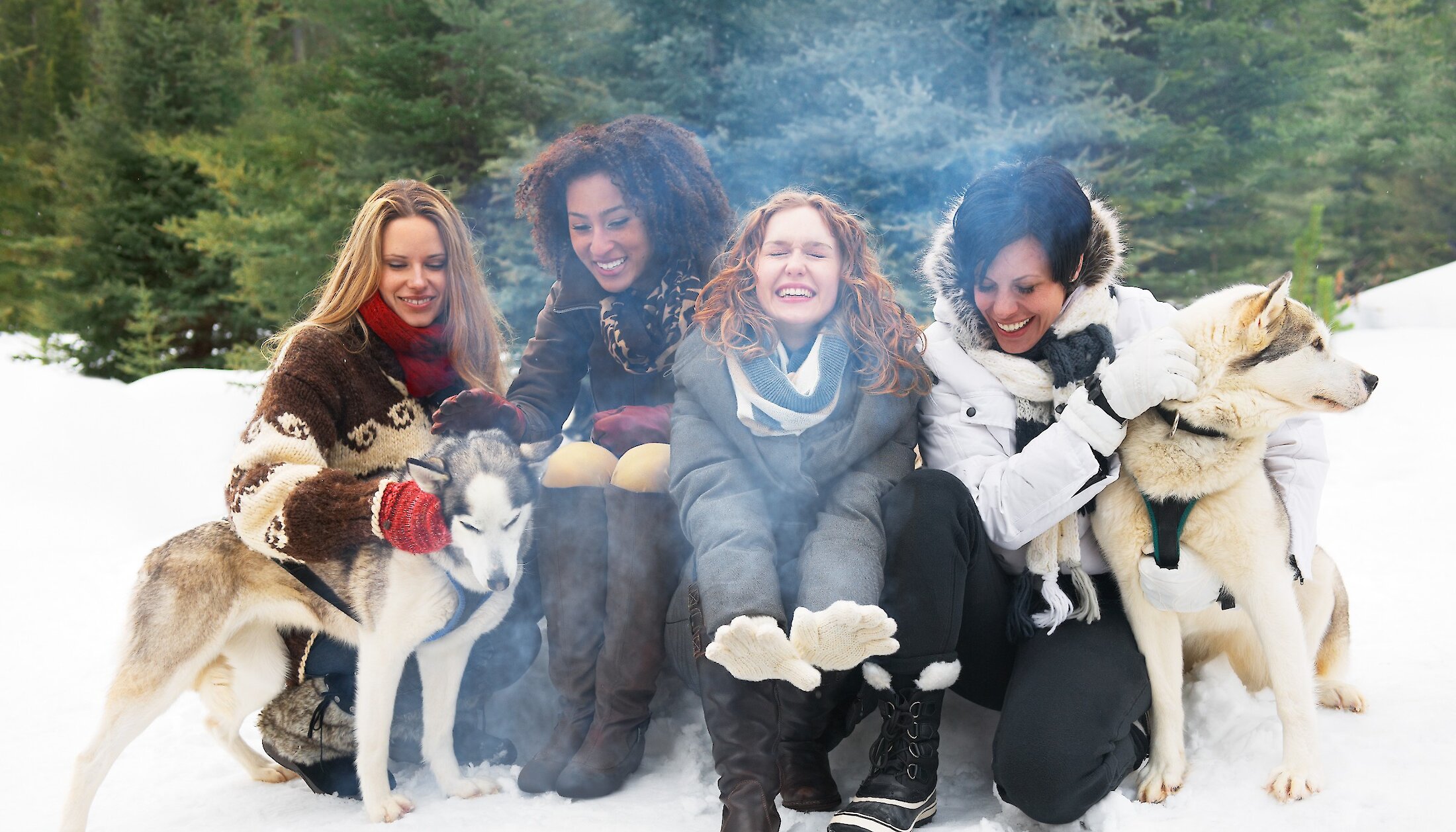 Warming up by the fire after a dogsled tour