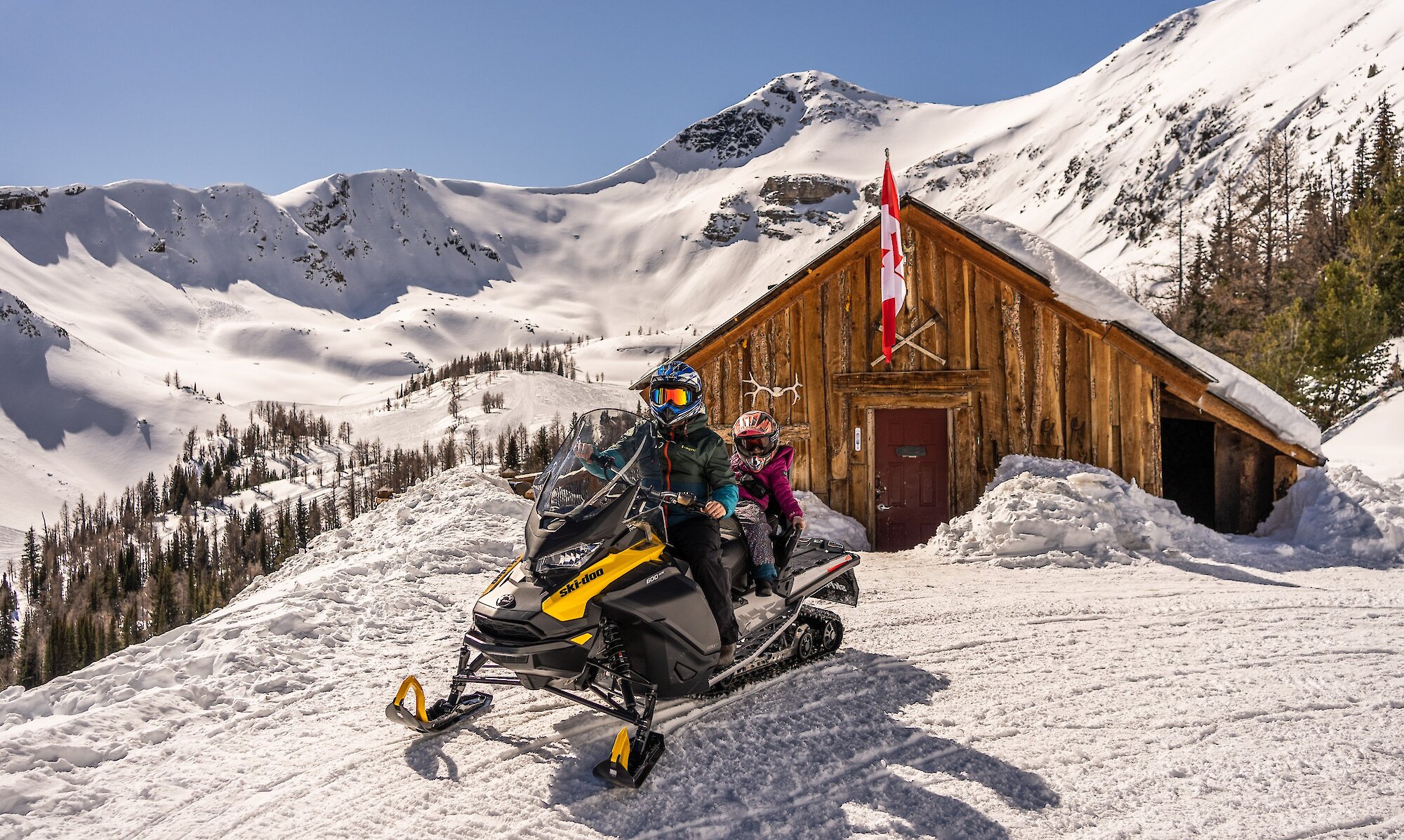 Guests at the cabin on the Paradise Basin snowmobile tour