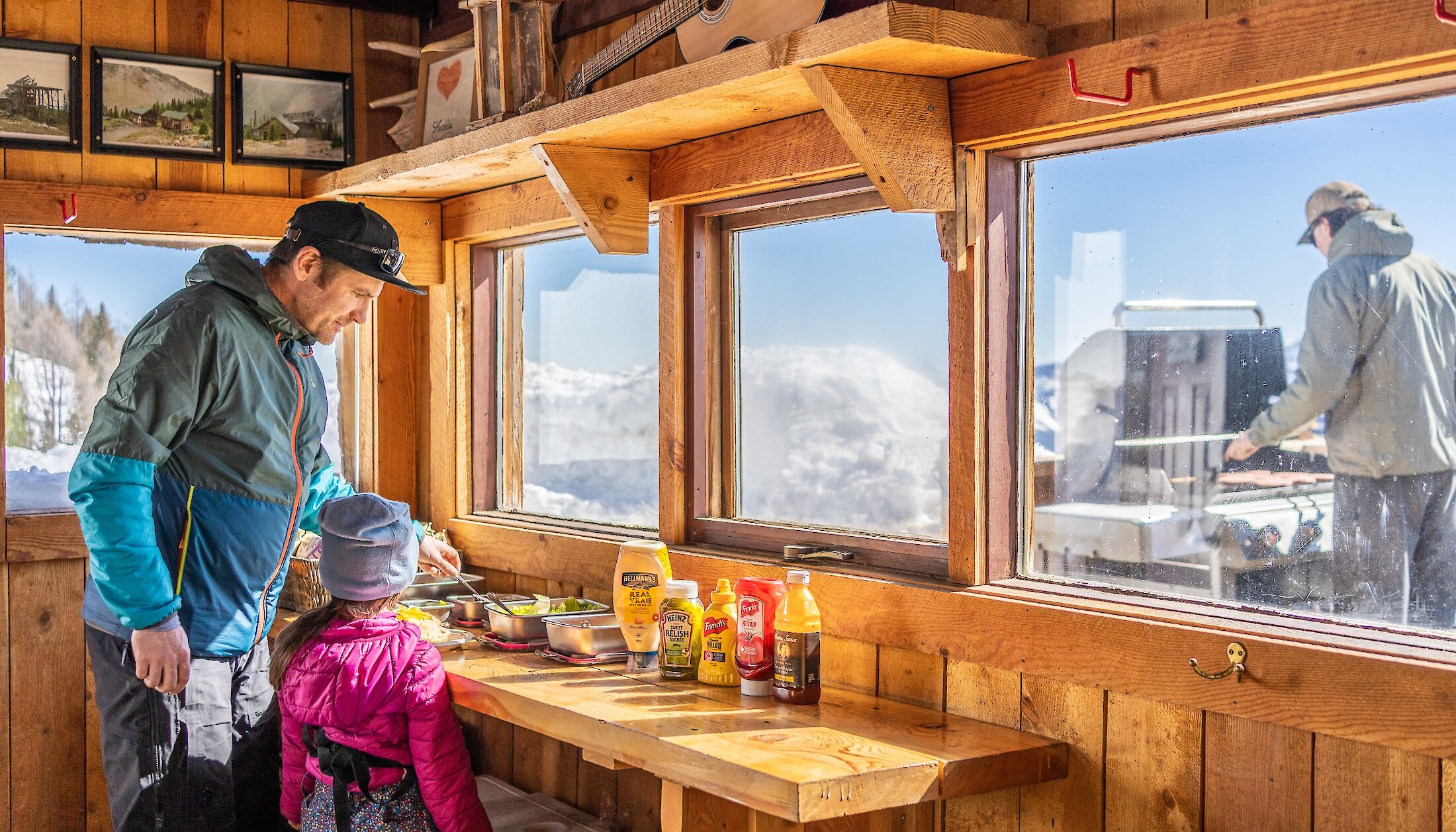 Family eating lunch at the Cabin on Paradise Basin Snowmobile tour