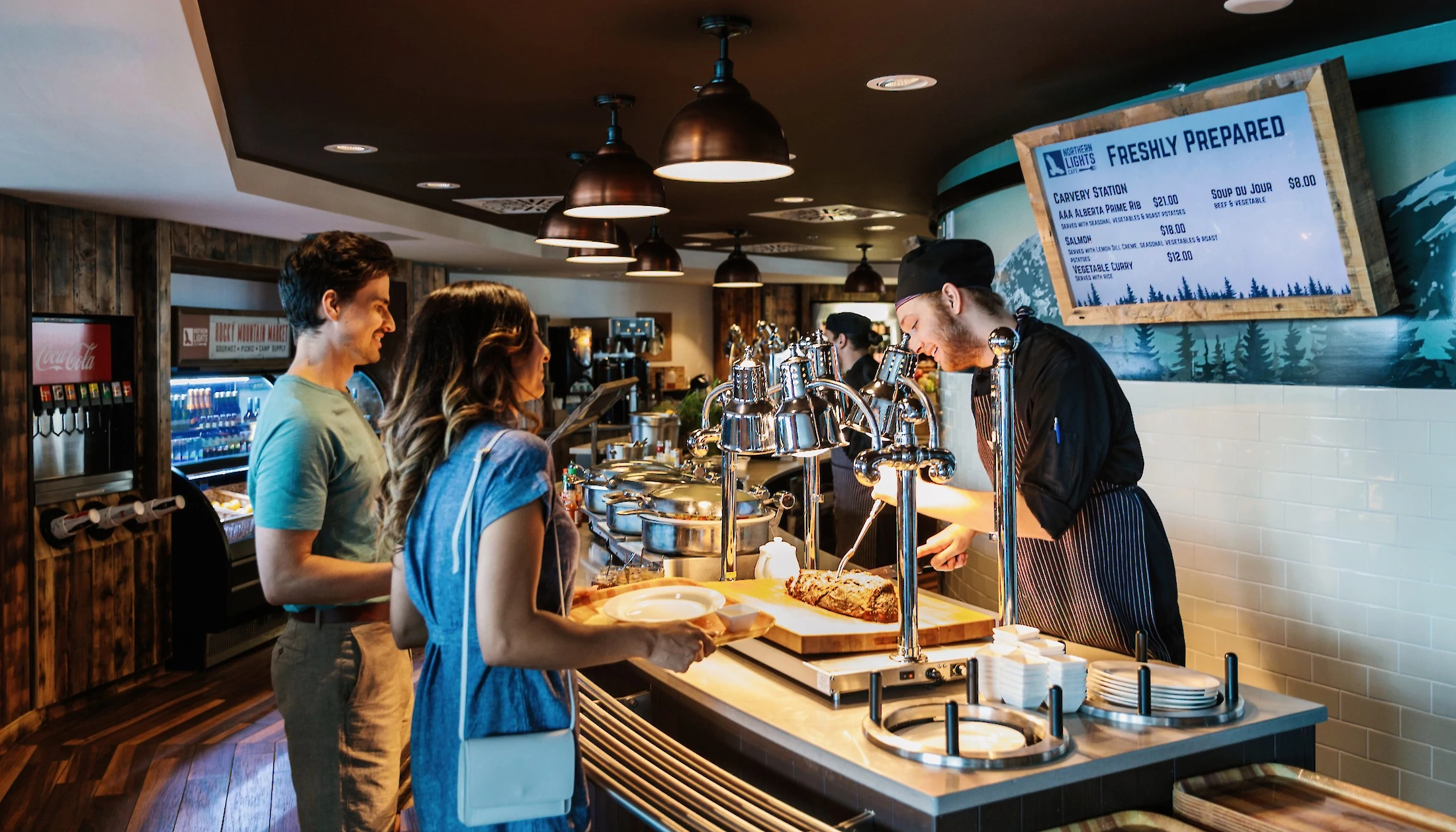 A couple being served at the Northern Lights Cafe Buffet at the Banff Gondola