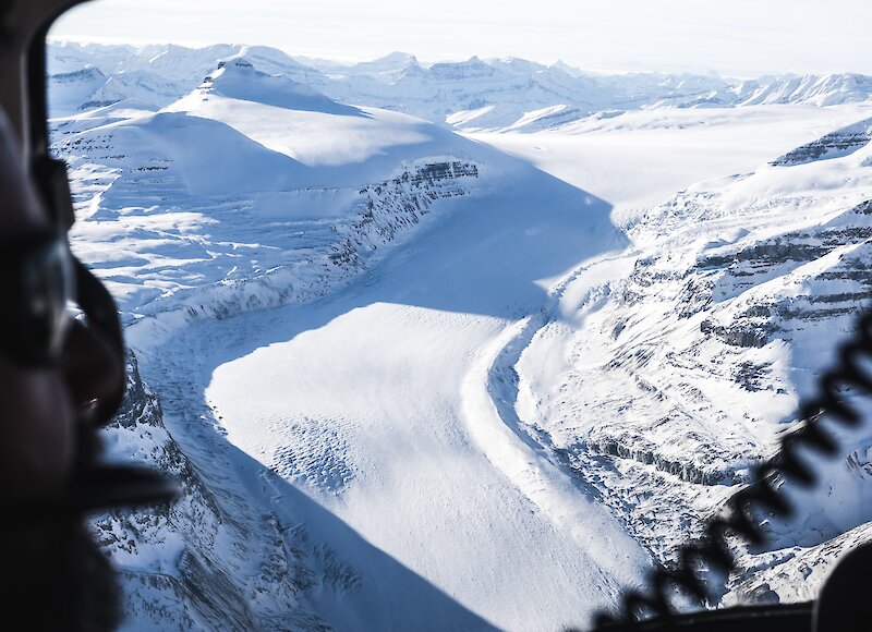 Flying over the athabasca glacier in a helicopter