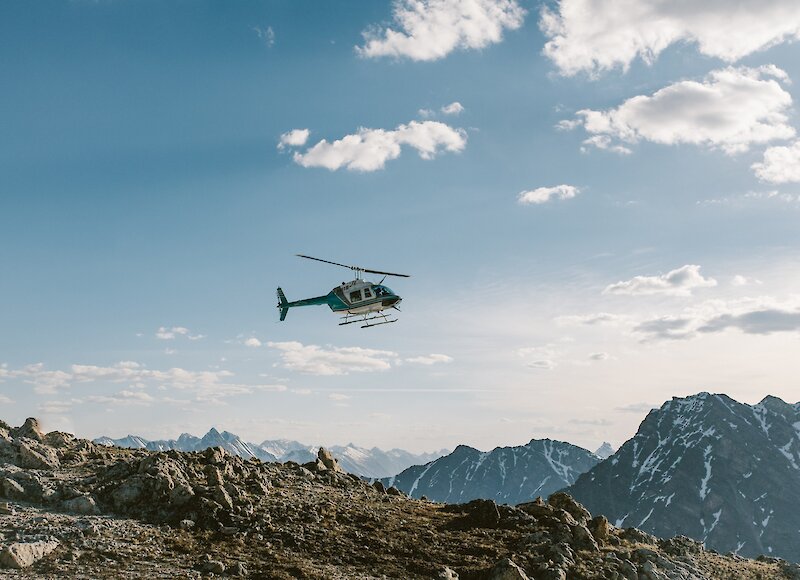 Helicopter landing at the top of a mountain