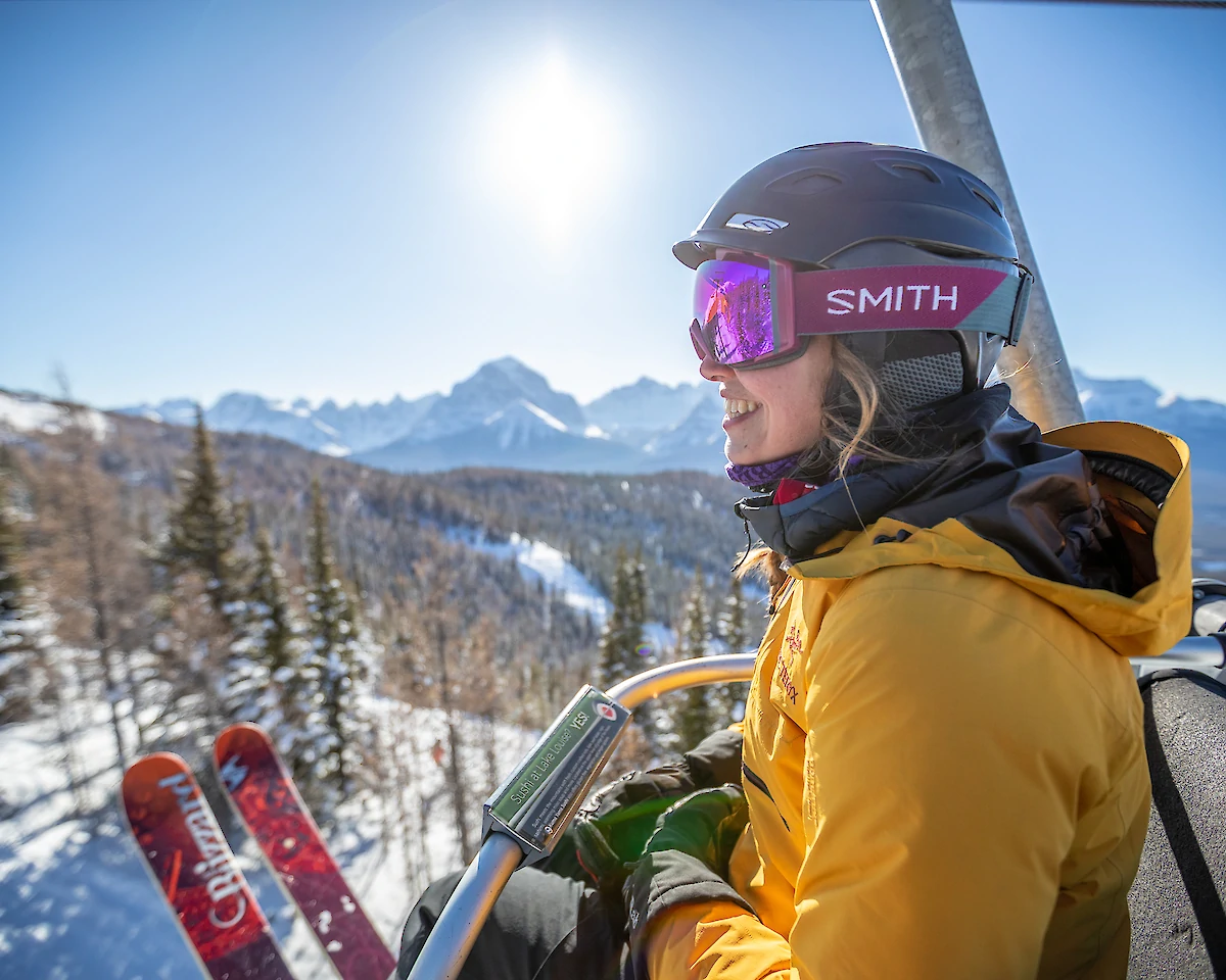 A skier enjoying a chairlift ride at Lake Louise Ski Resort