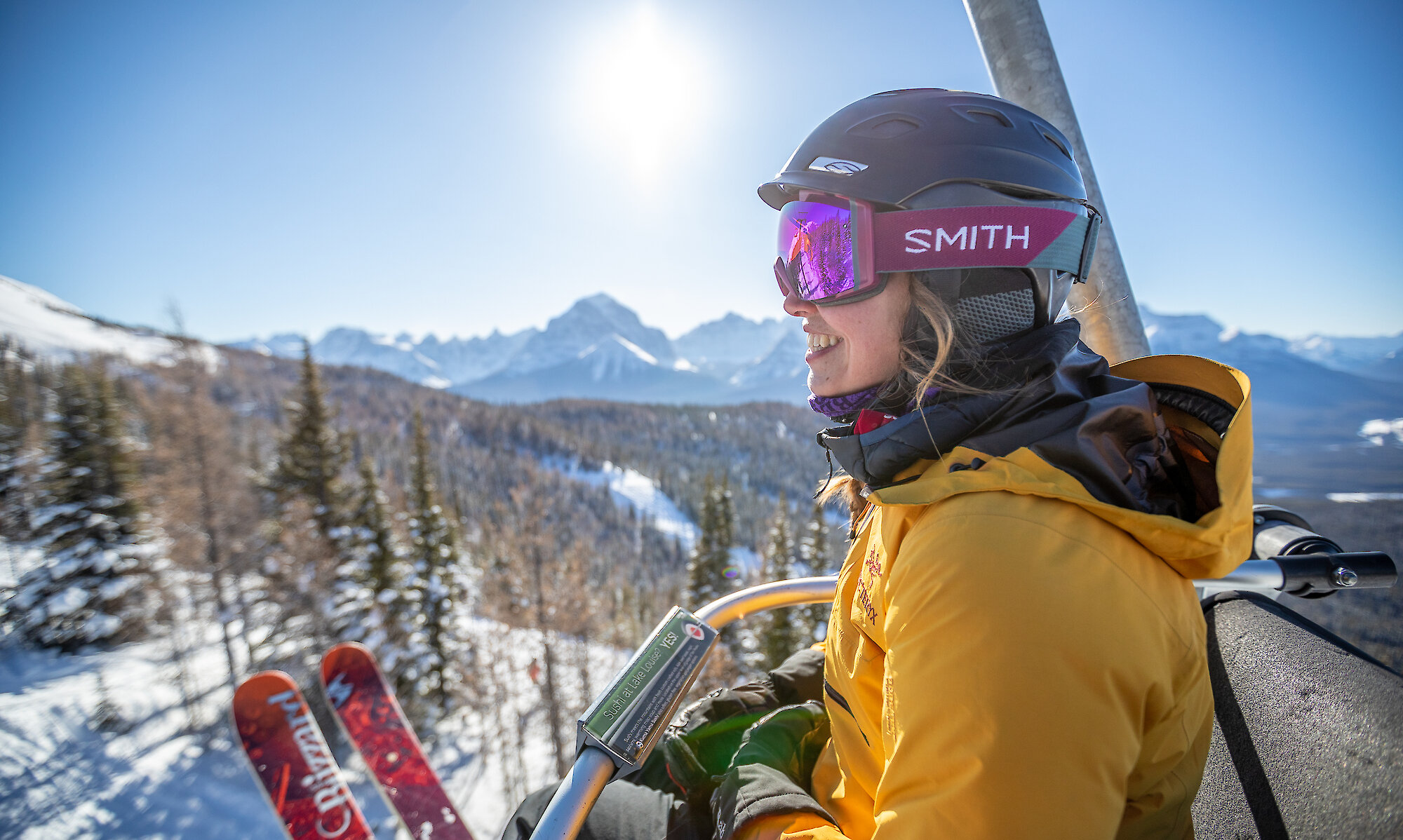 A skier enjoying a chairlift ride at Lake Louise Ski Resort