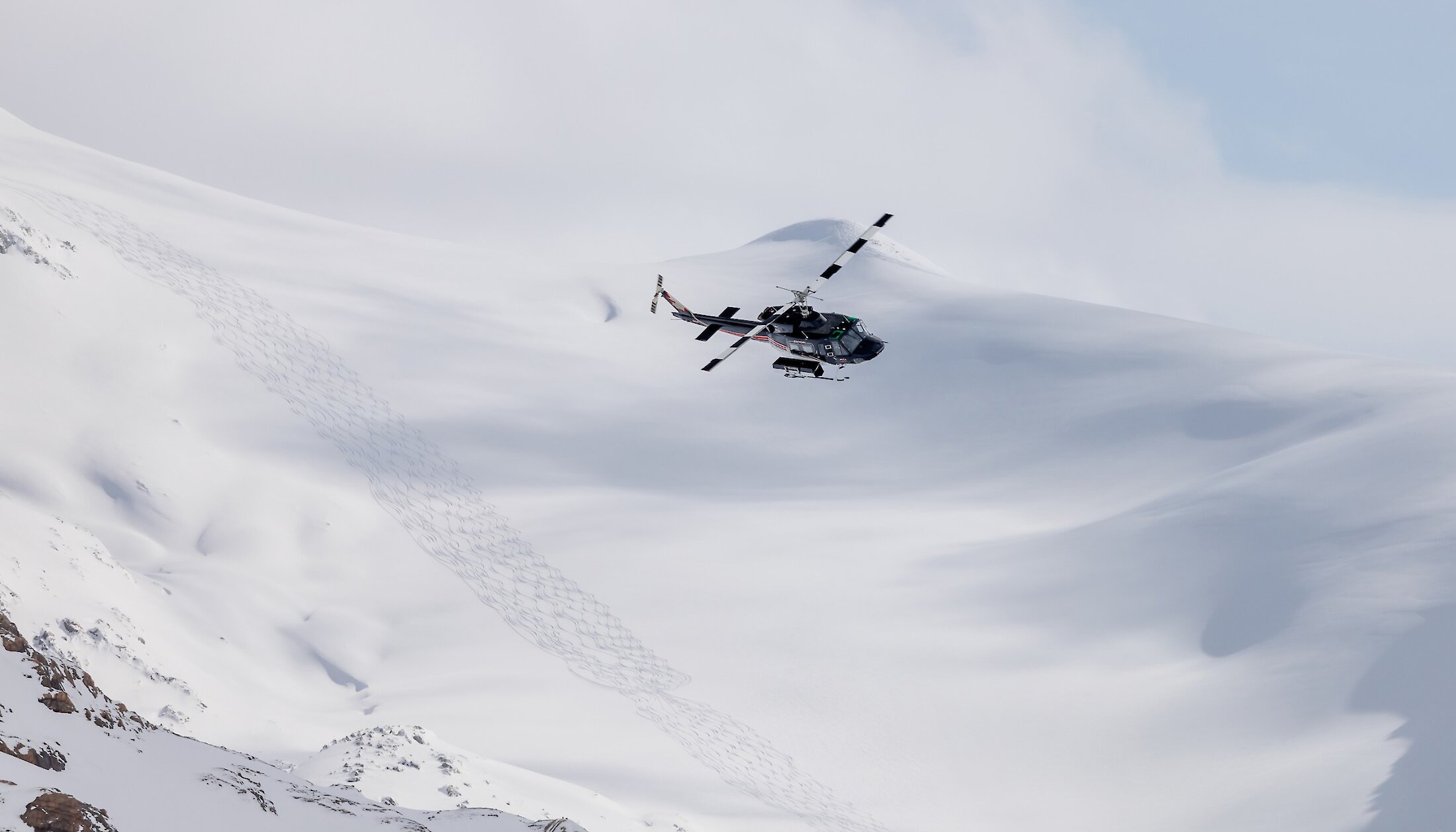 A helicopter on its way to drop off heliskiers