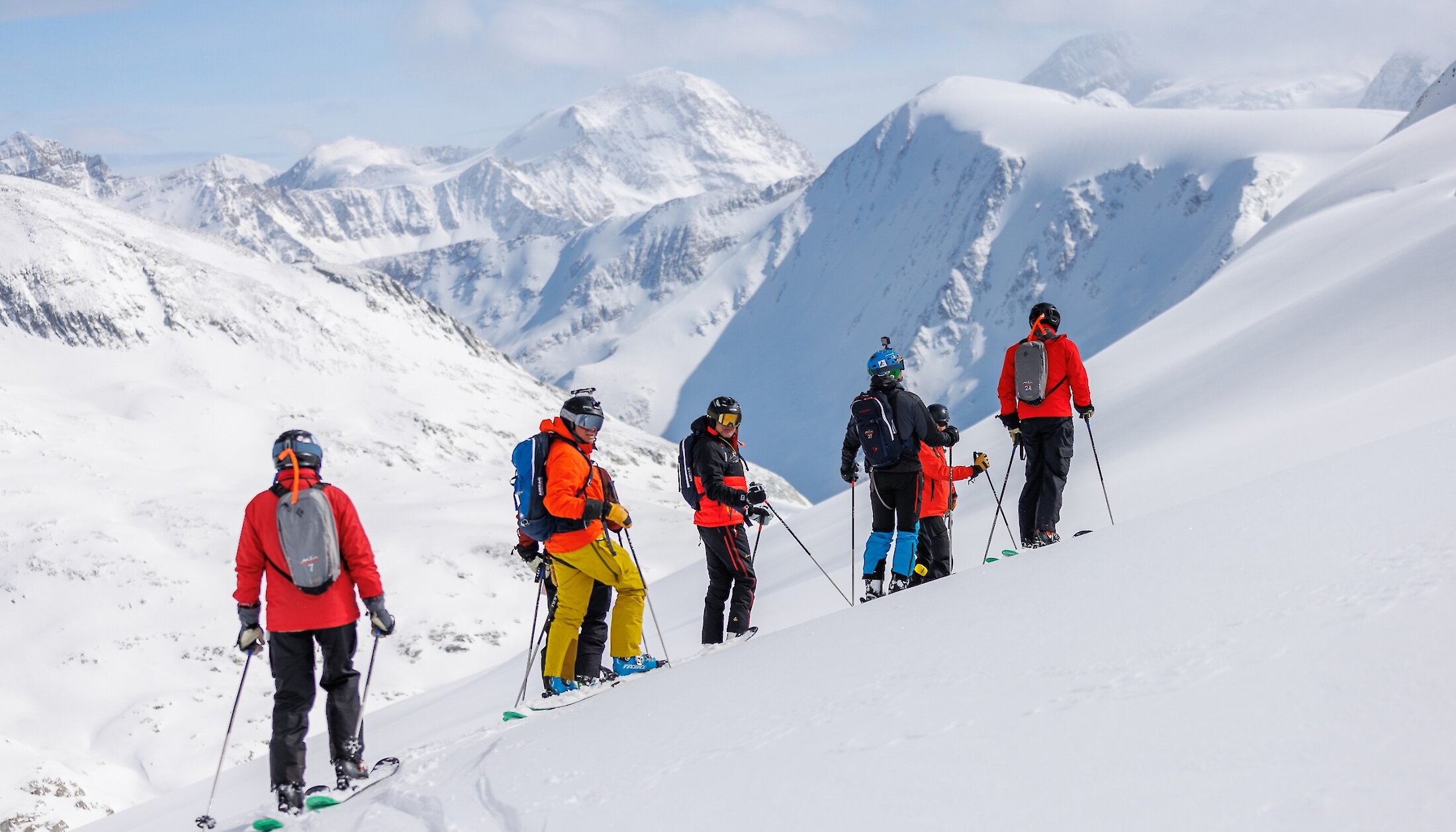 Heliskiers on the top of a mountain