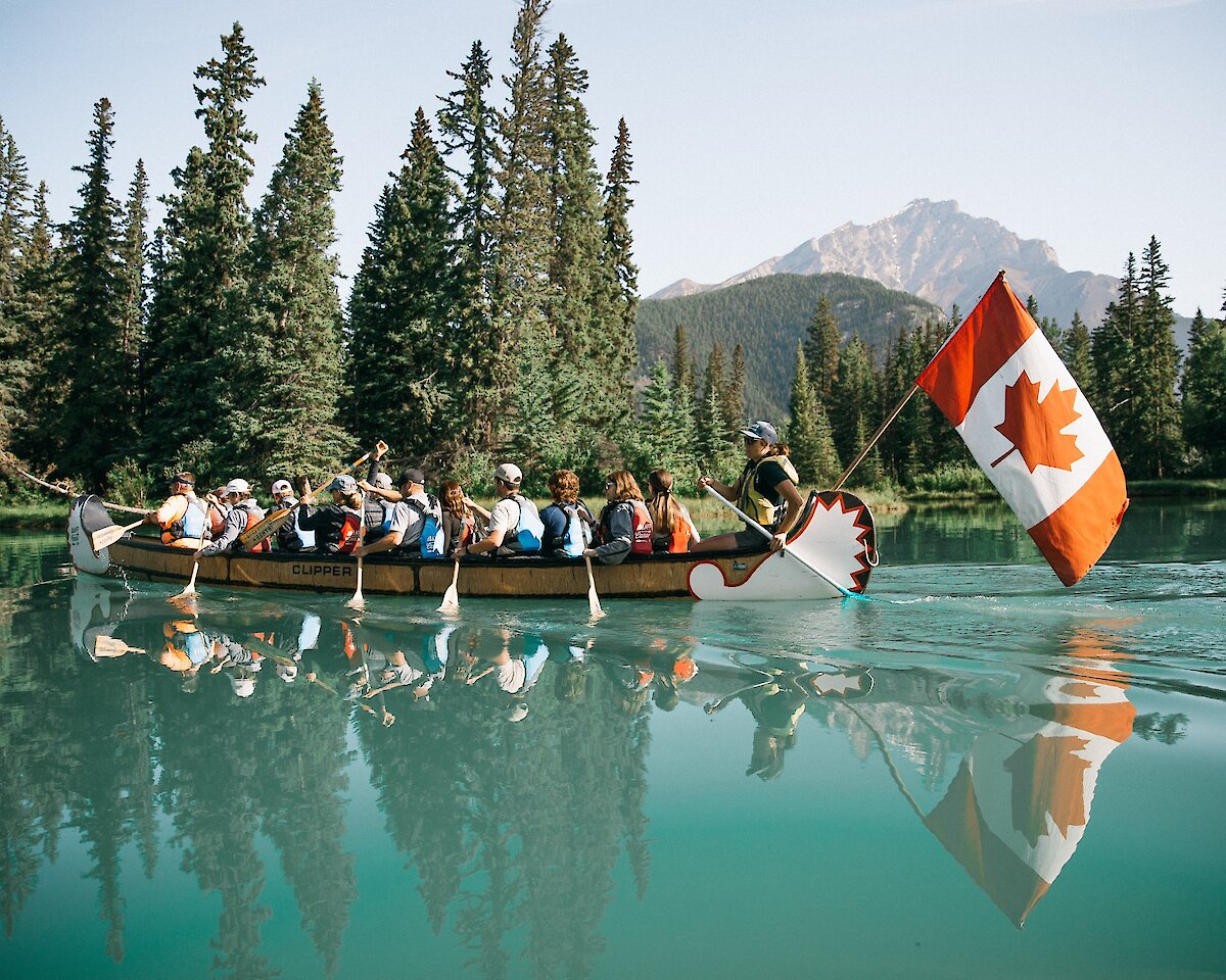A Big Canoe Tour paddling on the turquoise waters of the Bow River in Banff