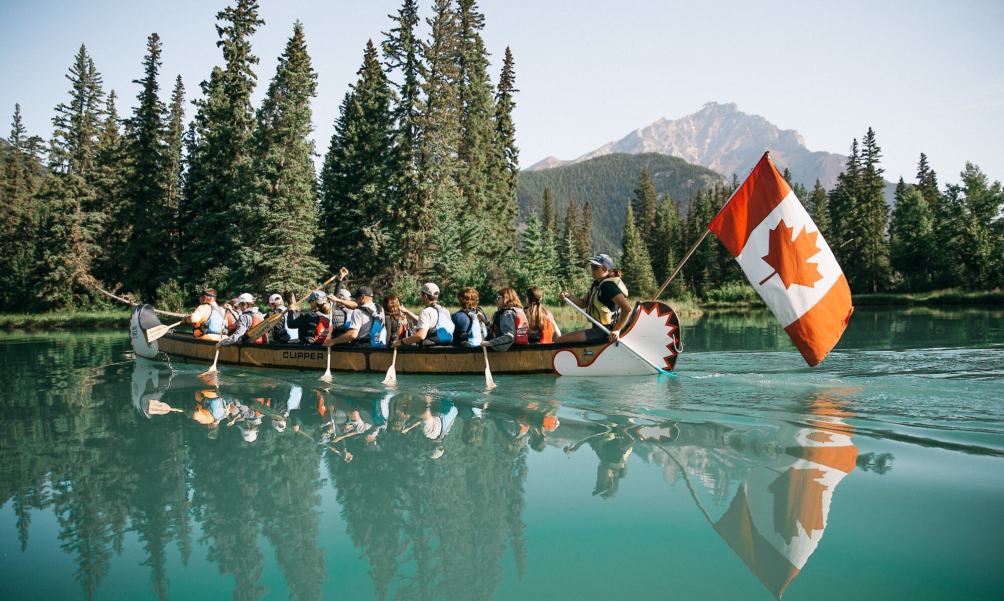 A Big Canoe Tour paddling on the turquoise waters of the Bow River in Banff
