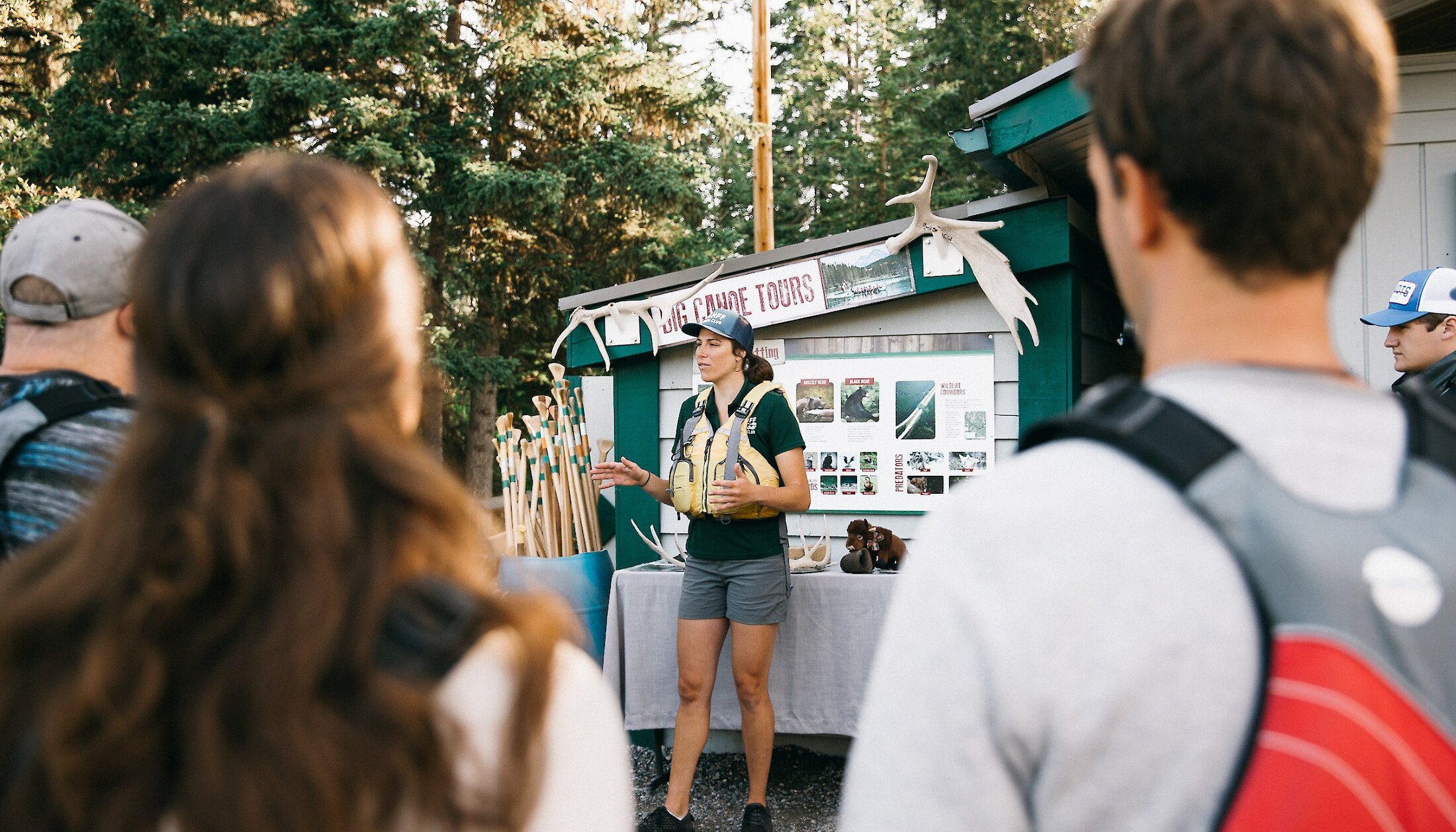 A tour guide giving an interpretive talk at the Banff Canoe Club before a Big Canoe Tour