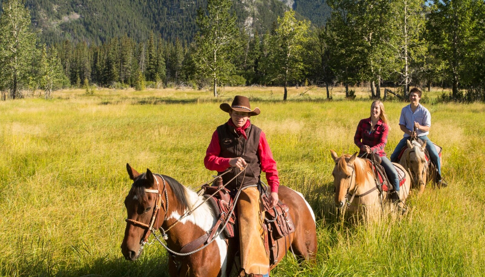 Trail riding through the grass in Banff National Park