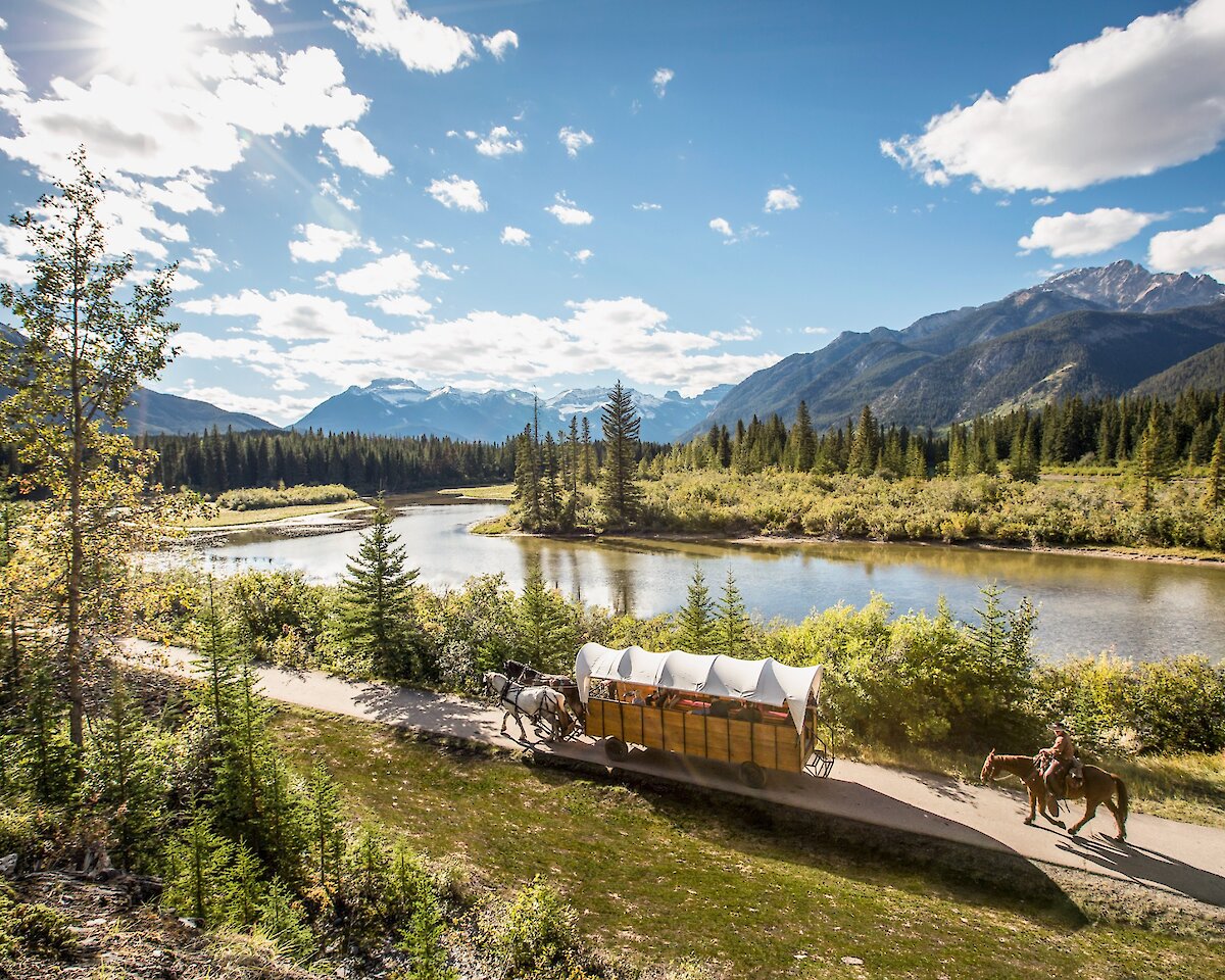 A horse drawn wagon ride along the Bow River In Banff