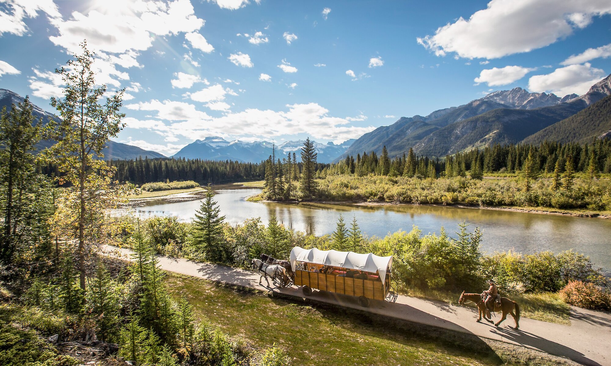 A horse drawn wagon ride along the Bow River In Banff