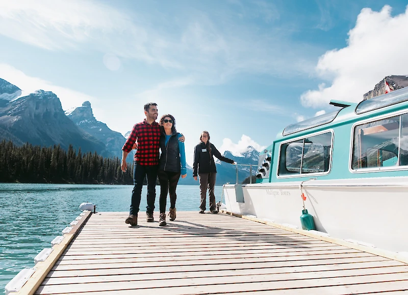 A couple disembarking a the Lake Cruise at Lake Minnewanka in Banff