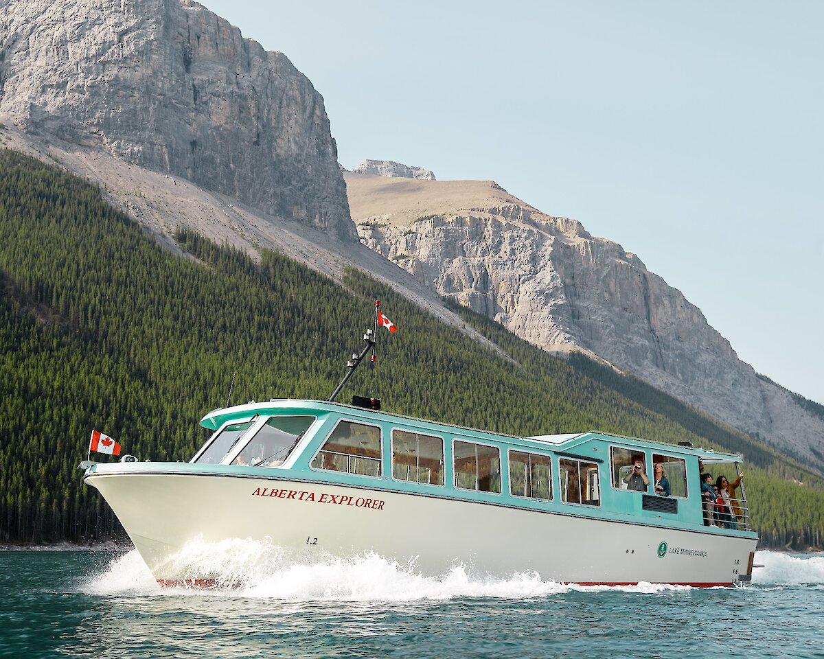 A boat cruise on Lake Minnewanka in Banff with mountains in the background