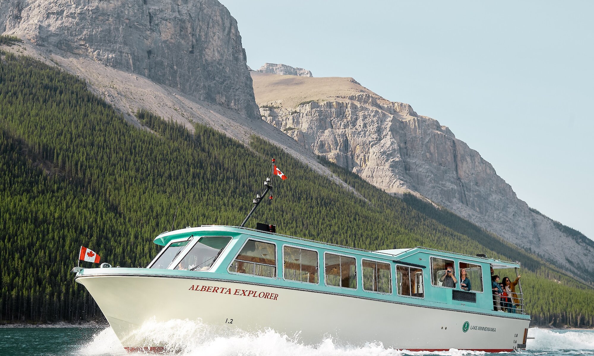 A boat cruise on Lake Minnewanka in Banff with mountains in the background