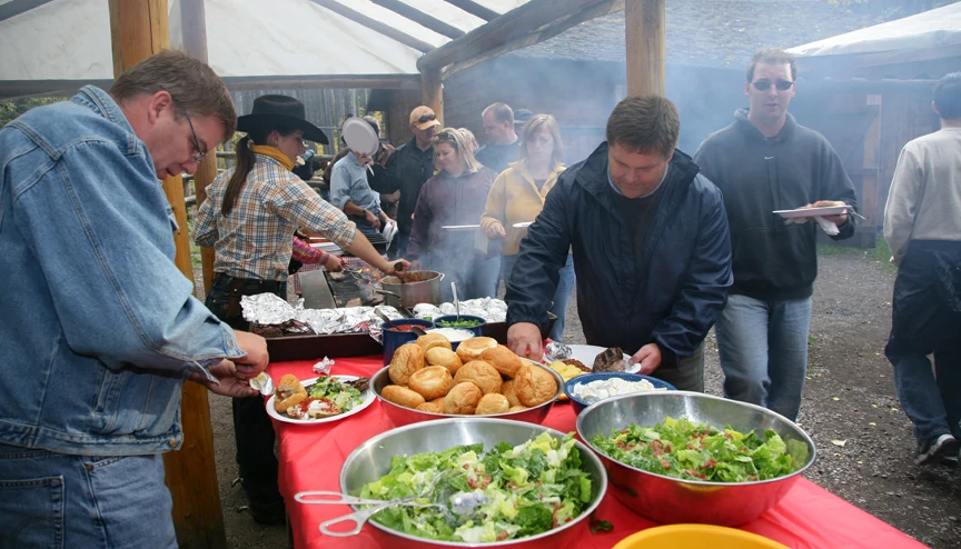 People enjoying a buffet a the cowboy cookout in Banff