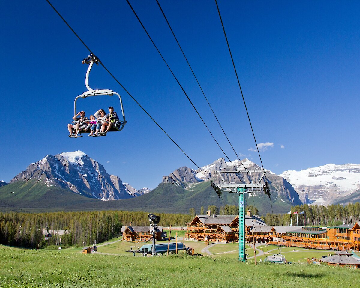 The Lake Louise sightseeing chairlift on a bluebird day with mountains in the background