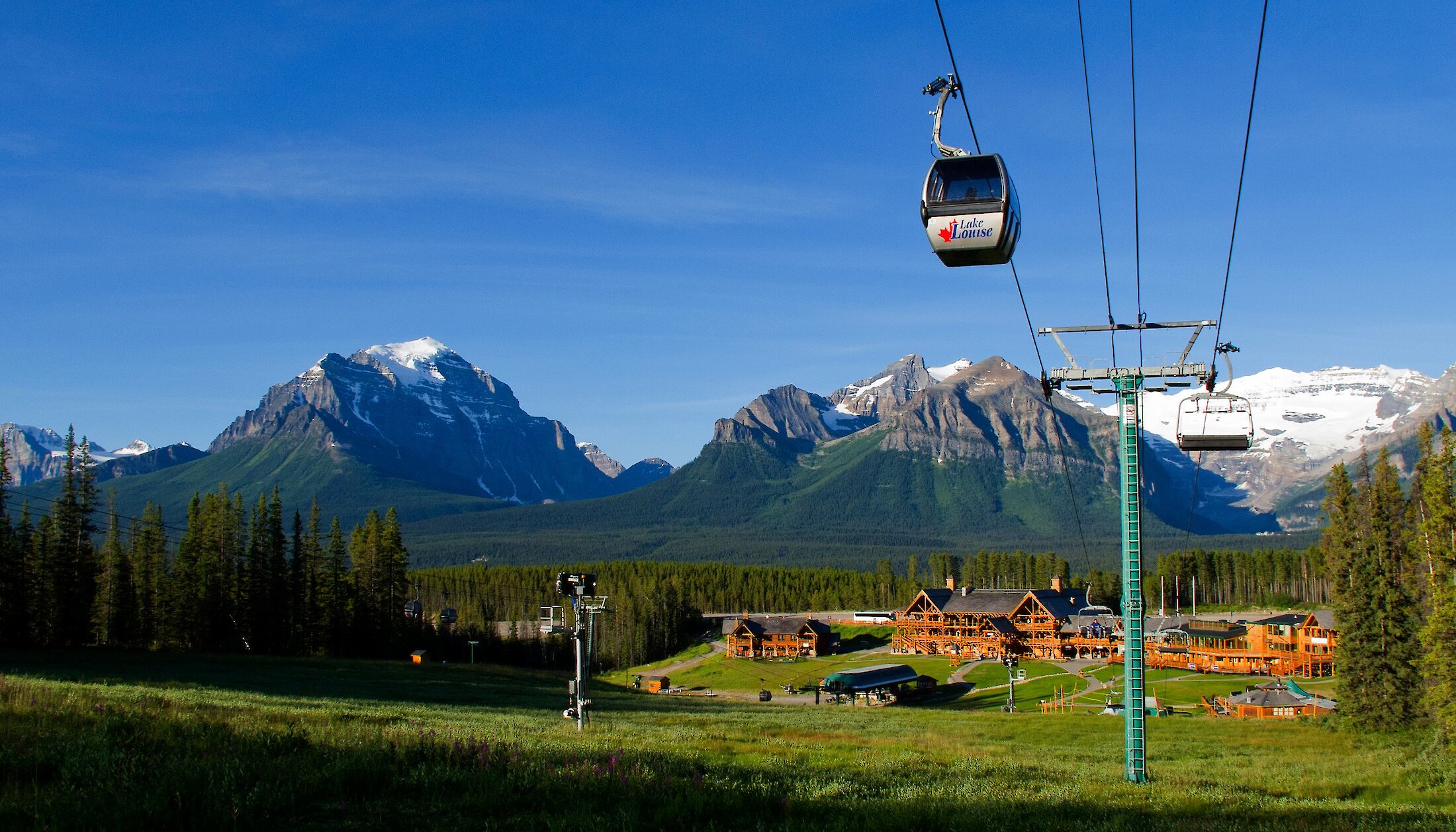The Lake Louise sightseeing Gondola coming over the luscious green grass